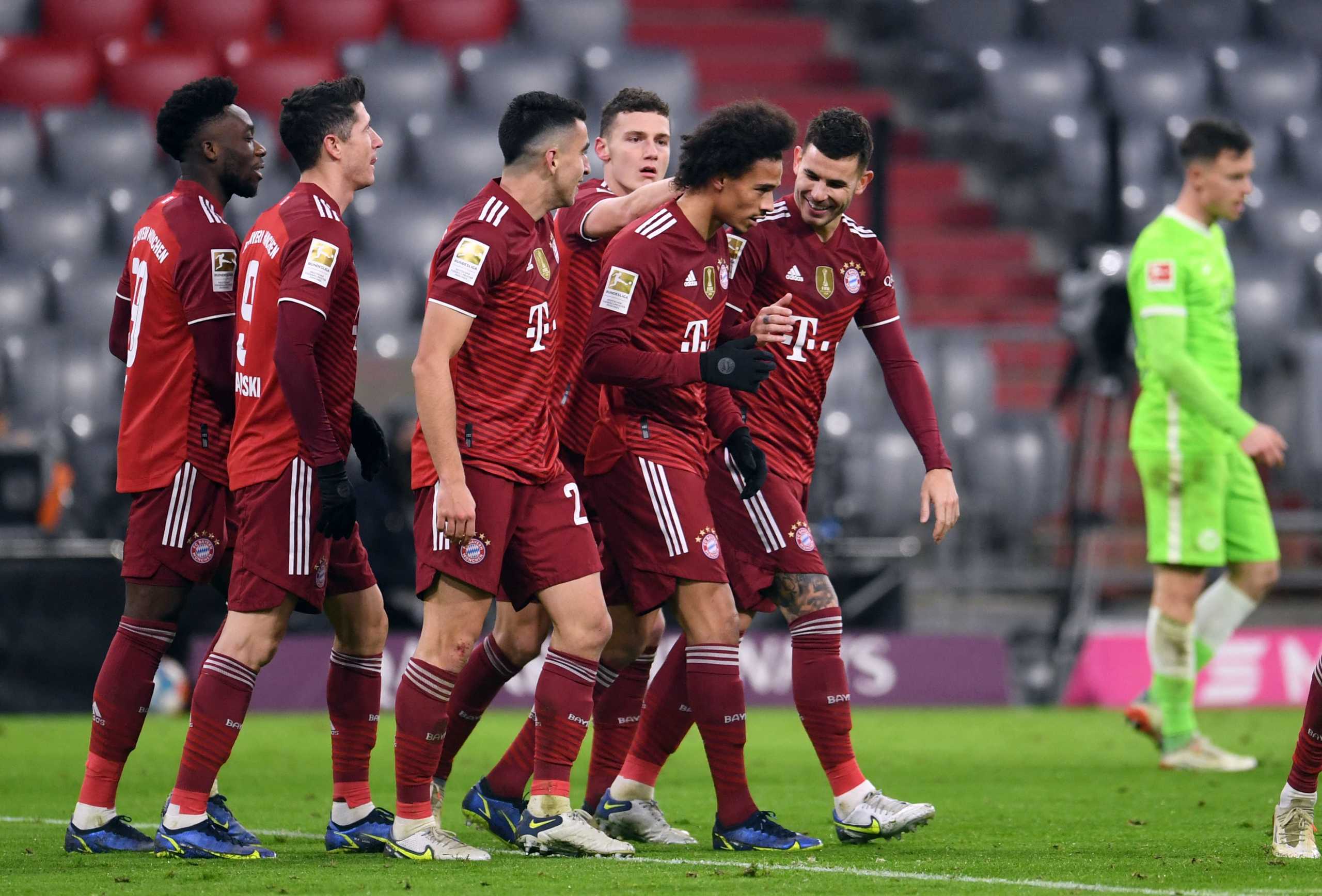 Soccer Football - Bundesliga - Bayern Munich v VfL Wolfsburg - Allianz Arena, Munich, Germany - December 17, 2021  Bayern Munich's Leroy Sane celebrates scoring their third goal with teammates REUTERS