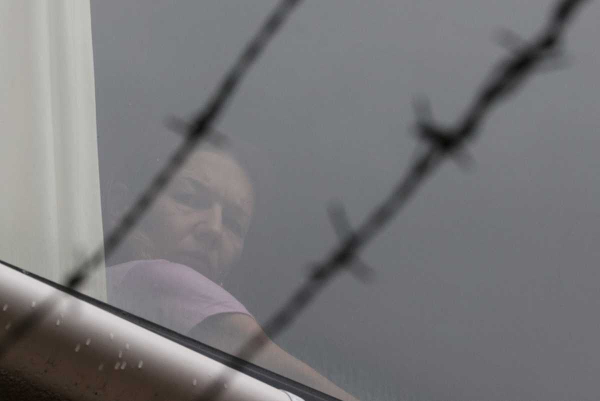 Tennis player Renata Voracova of the Czech Republic looks out a window at the Park Hotel where she is being held while she stays in Australia following the cancellation of her visa, the same government facility where Serbian tennis player Novak Djokovic is believed to be, in Melbourne, Australia, January 8, 2022.  REUTERS