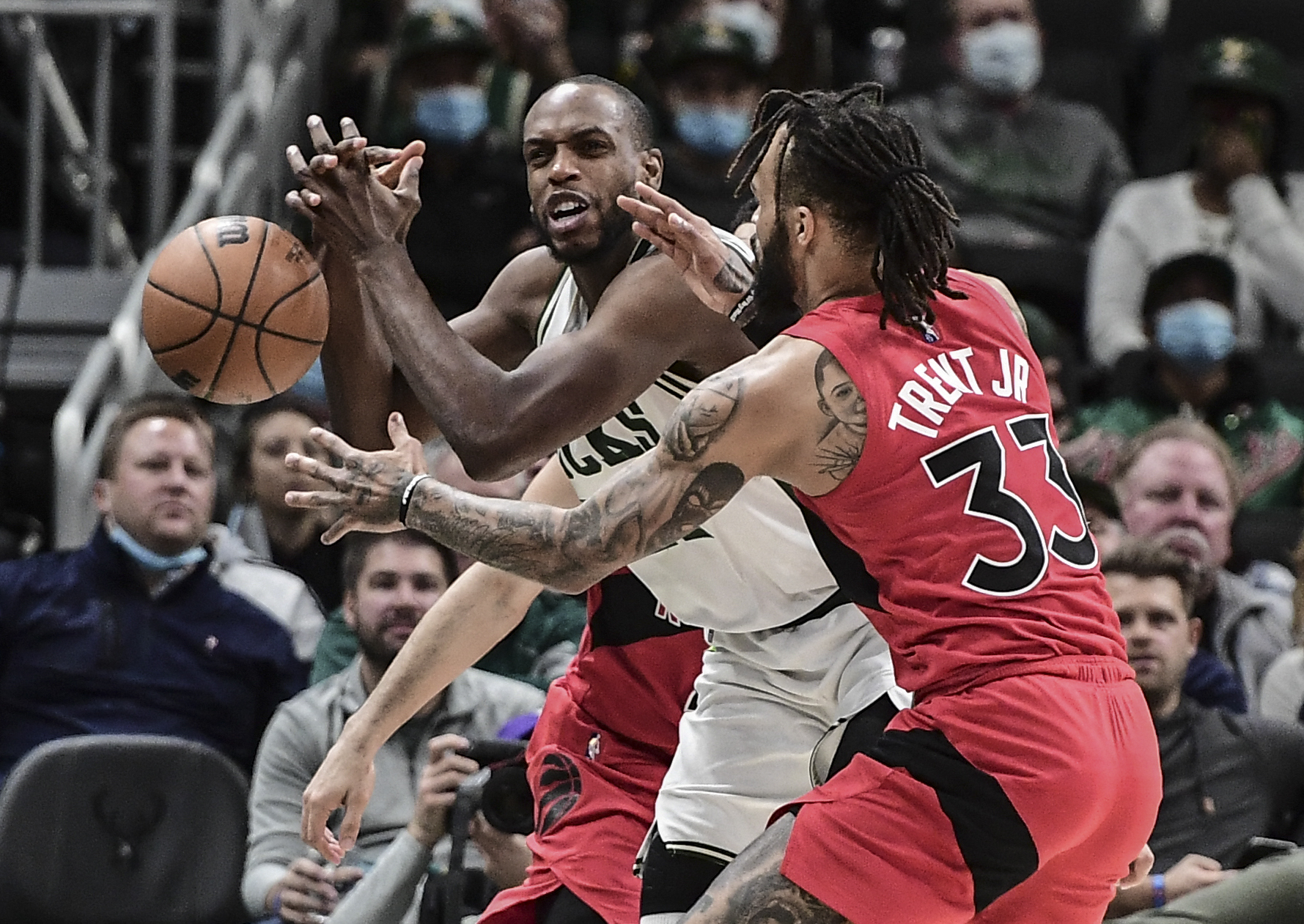 Jan 5, 2022; Milwaukee, Wisconsin, USA;  Toronto Raptors guard Gary Trent Jr. (33) tries to steal the ball from Milwaukee Bucks forward Khris Middleton (22) in the fourth quarter at Fiserv Forum. Mandatory Credit: Benny Sieu-USA TODAY Sports