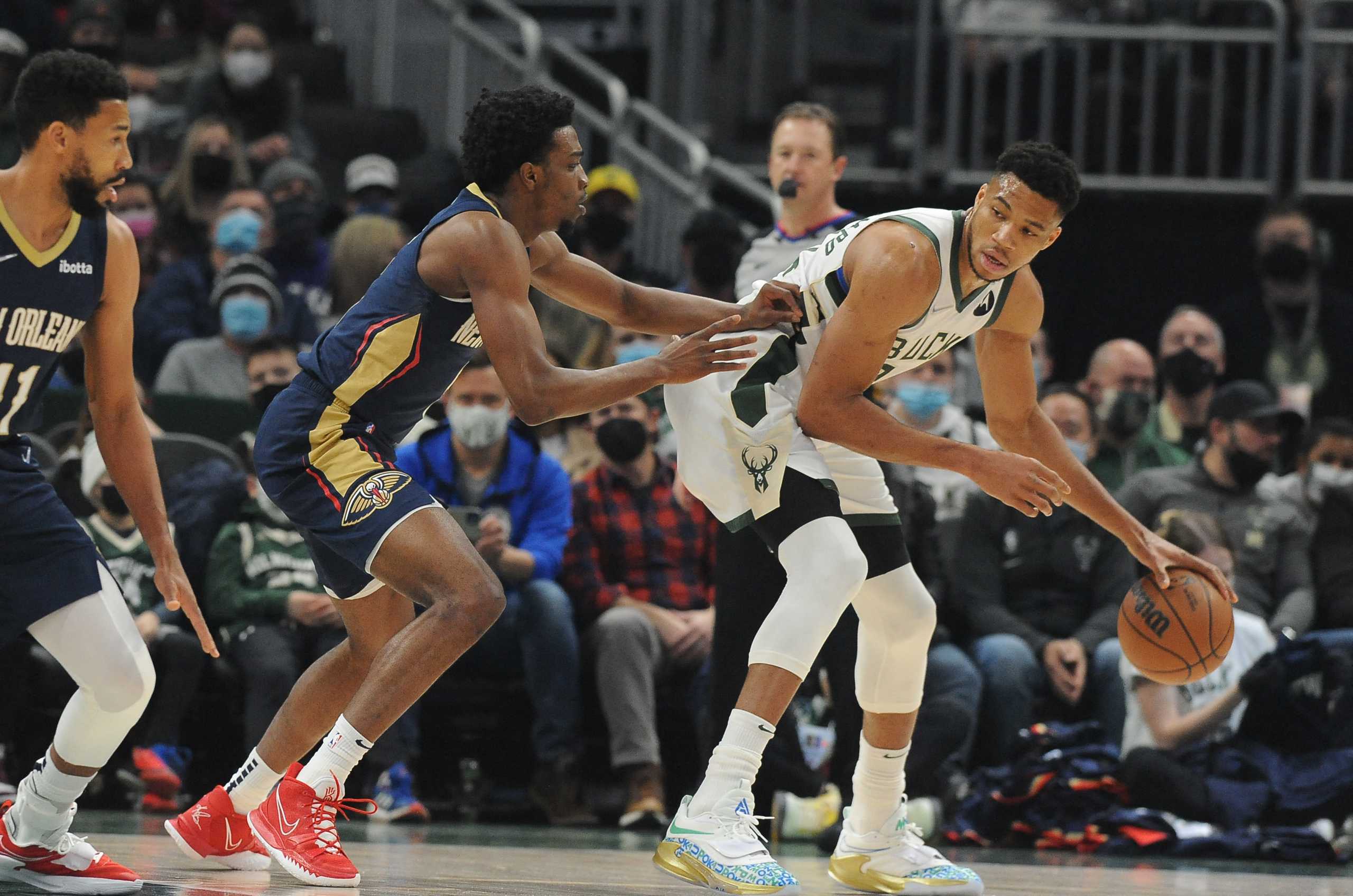 Jan 1, 2022; Milwaukee, Wisconsin, USA;  Milwaukee Bucks forward Giannis Antetokounmpo (34) controls the ball against New Orleans Pelicans forward Herbert Jones (5) in the first half at Fiserv Forum. Mandatory Credit: Michael McLoone-USA TODAY Sports