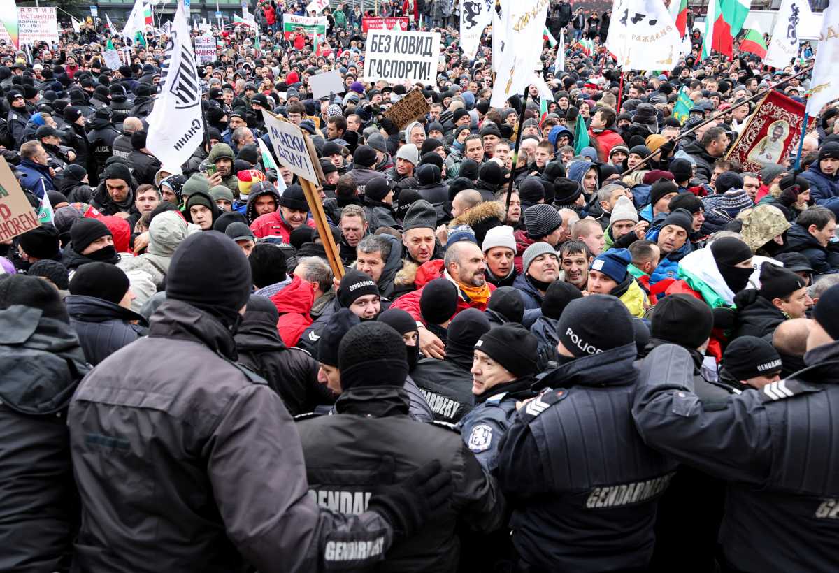 Protestors scuffle with police as they try to enter the parliament building during a rally organised by the political party Vazrazhdane (Revival) against the government measures to curb the spread of the coronavirus disease (COVID-19), in Sofia, Bulgaria, January 12, 2022. REUTERS