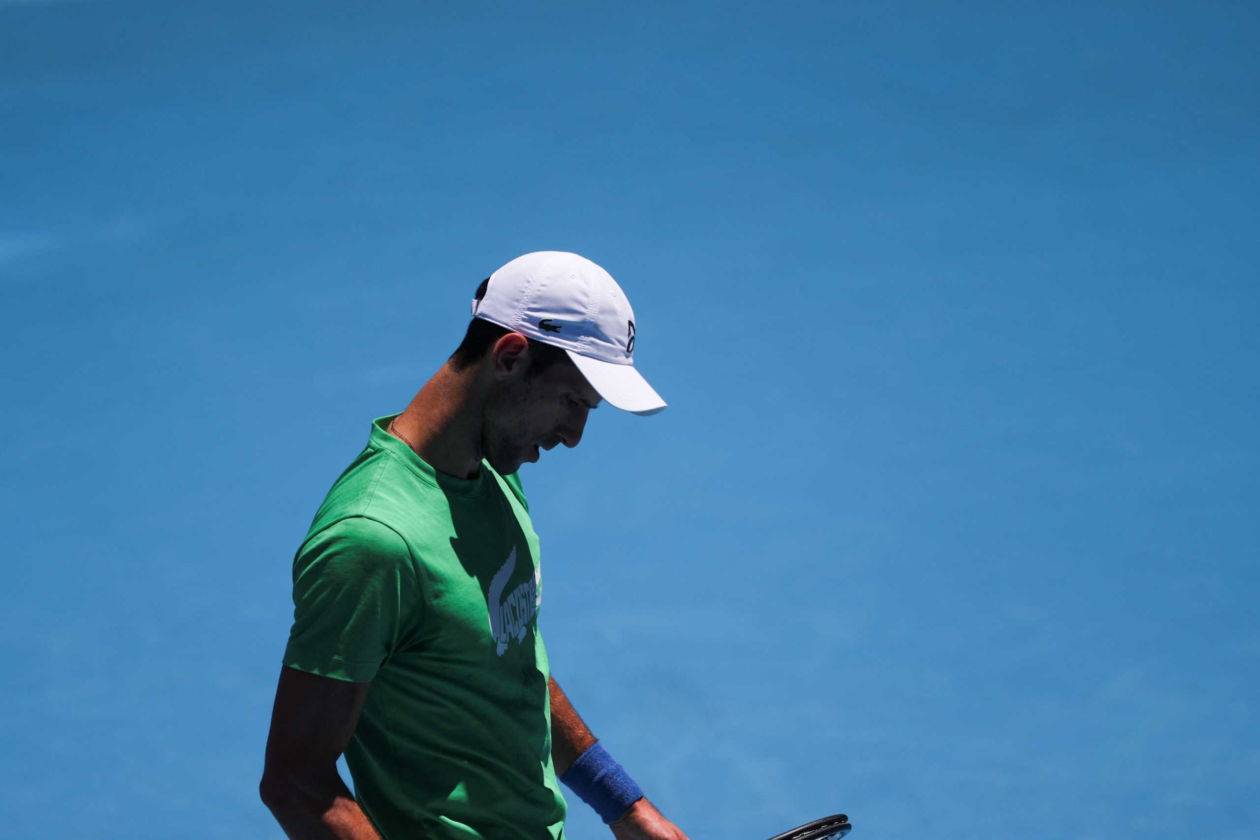 Serbian tennis player Novak Djokovic practices at Melbourne Park as questions remain over the legal battle regarding his visa to play in the Australian Open in Melbourne, Australia, January 13, 2022.  REUTERS