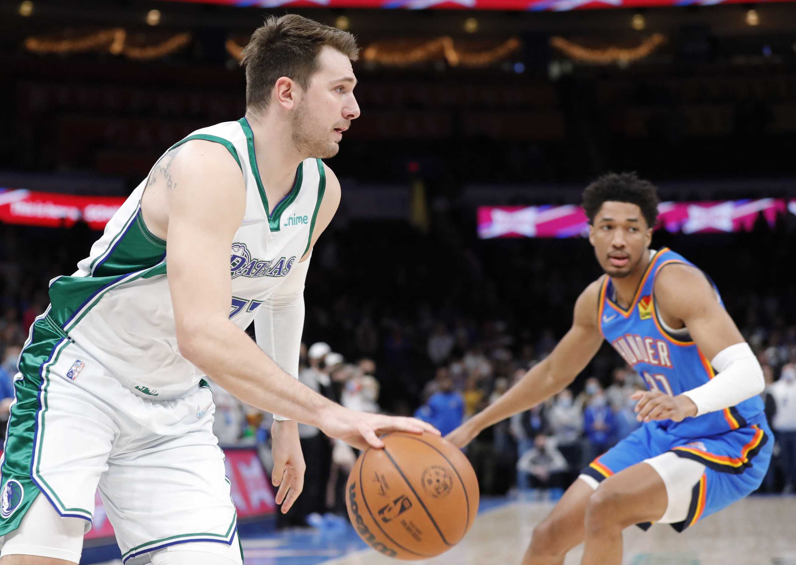 Jan 2, 2022; Oklahoma City, Oklahoma, USA; Dallas Mavericks guard Luka Doncic (77) drives to the basket around Oklahoma City Thunder guard Aaron Wiggins (21) during the first quarter at Paycom Center. Mandatory Credit: Alonzo Adams-USA TODAY Sports