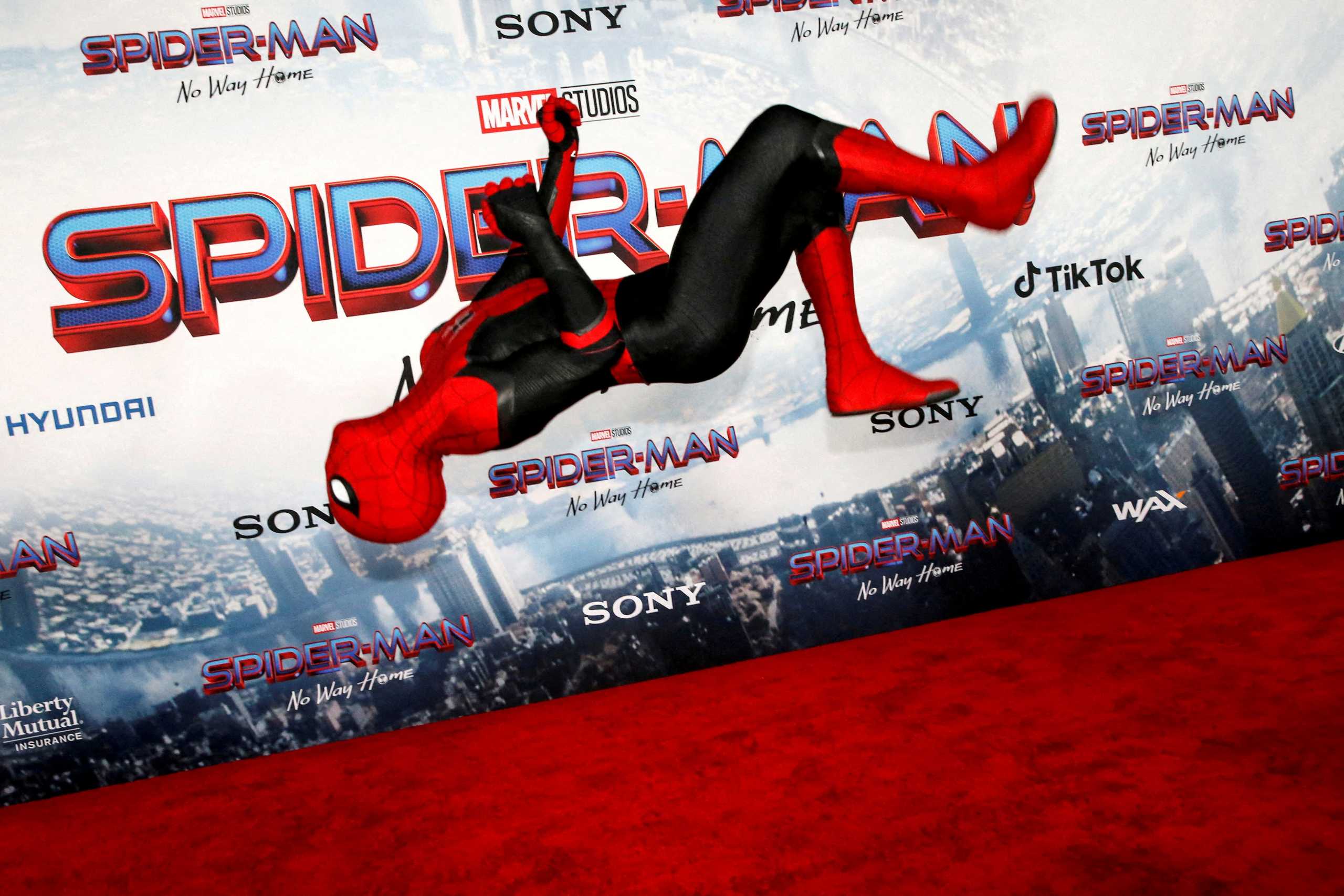 FILE PHOTO: A person dressed in Spider-Man costume performs at the premiere for the film Spider-Man: No Way Home in Los Angeles, California, December 13, 2021. REUTERS