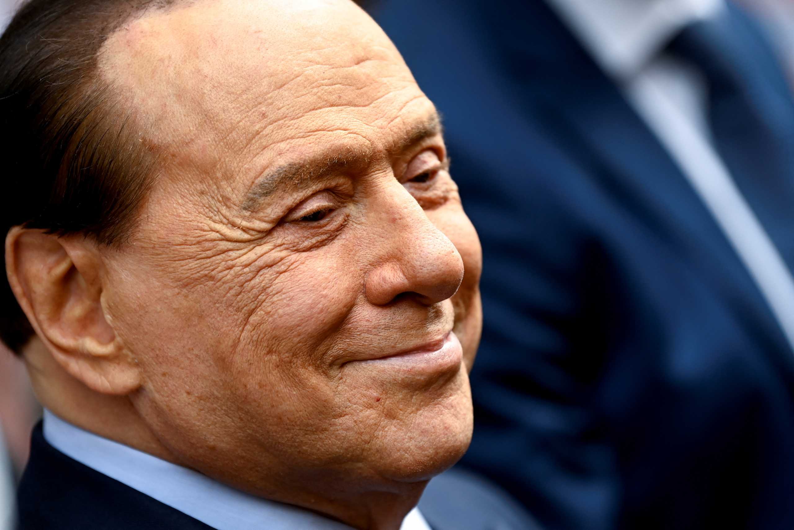 FILE PHOTO: Italy's former prime minister, Silvio Berlusconi, reacts after casting his vote during Italian elections for mayors and councillors, in Milan, Italy, October 3, 2021. REUTERS