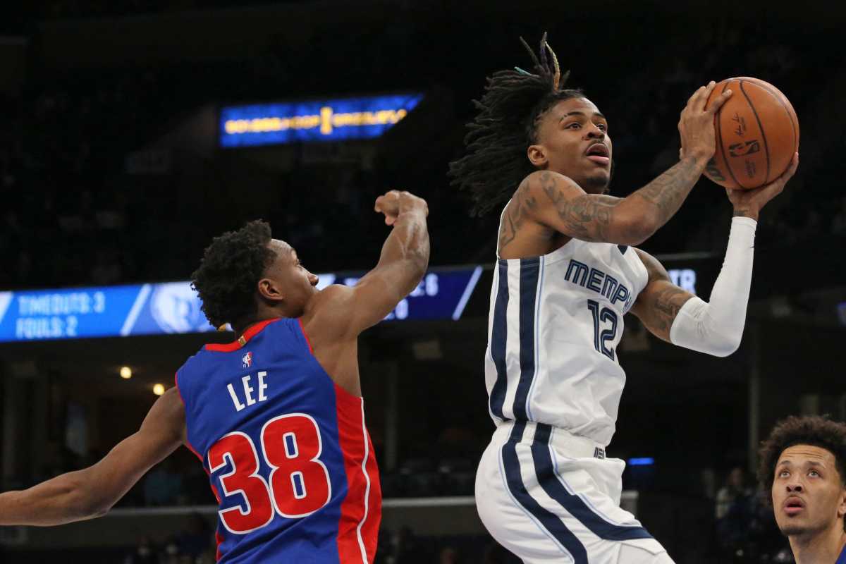 Jan 6, 2022; Memphis, Tennessee, USA; Memphis Grizzles guard Ja Morant (12) drives to the basket as Detroit Pistons guard Saben Lee (38) defends during the second half at FedExForum. Mandatory Credit: Petre Thomas-USA TODAY Sports