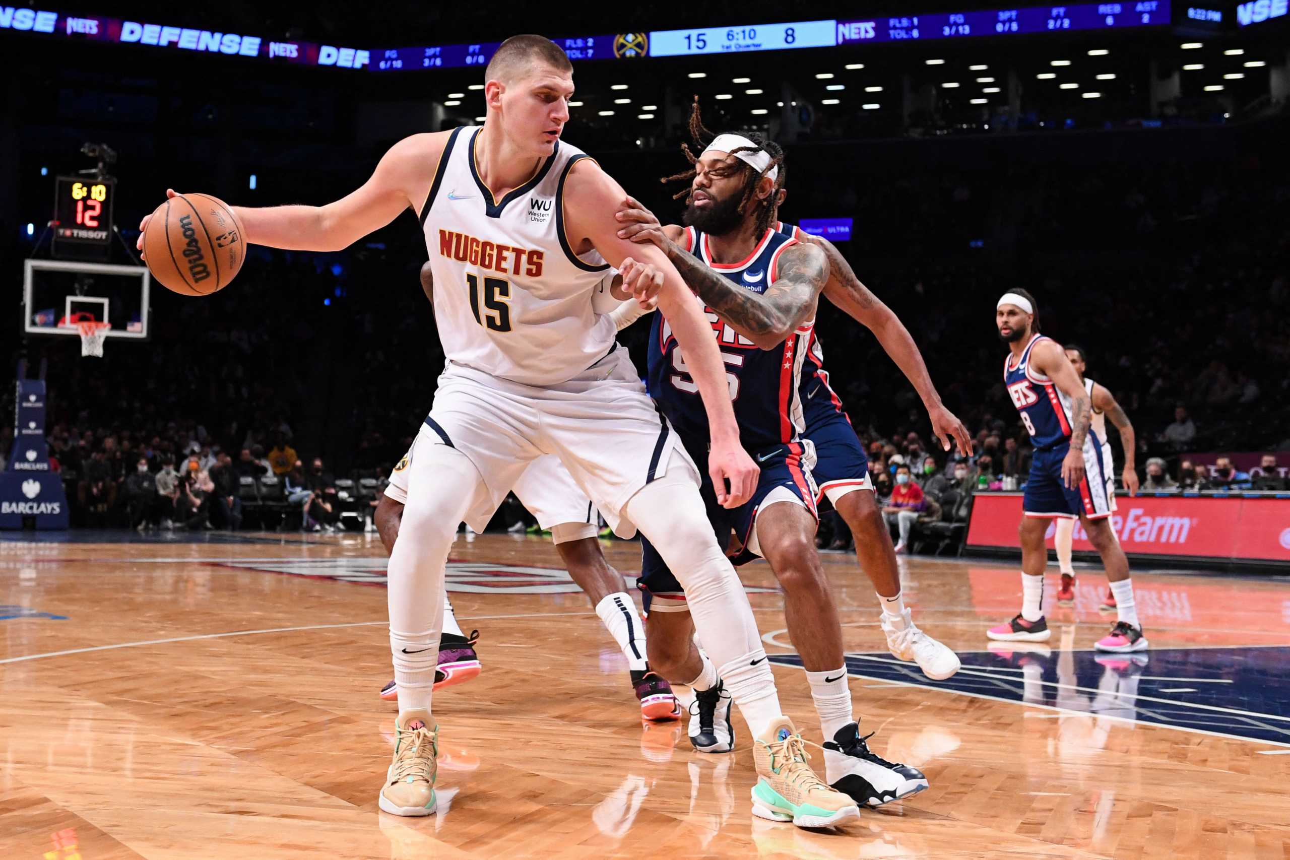 Jan 26, 2022; Brooklyn, New York, USA;  Brooklyn Nets guard DeAndre' Bembry (95) defends against Denver Nuggets center Nikola Jokic (15) during the first quarter at Barclays Center. Mandatory Credit: Dennis Schneidler-USA TODAY Sports