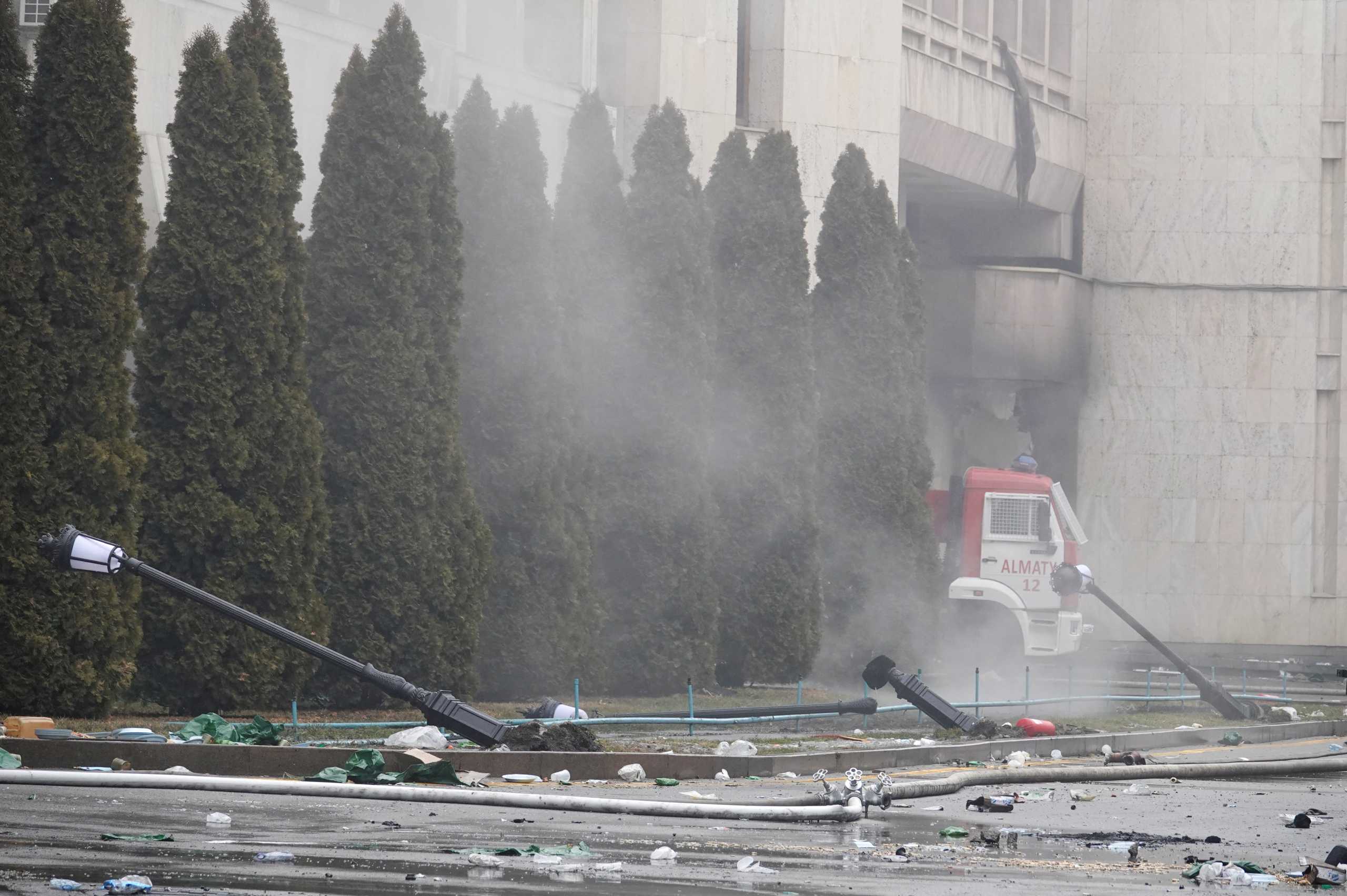 A firefighting vehicle is seen outside the city administration headquarters, which was set on fire during the protests triggered by fuel price increase, in Almaty, Kazakhstan January 7, 2022. REUTERS