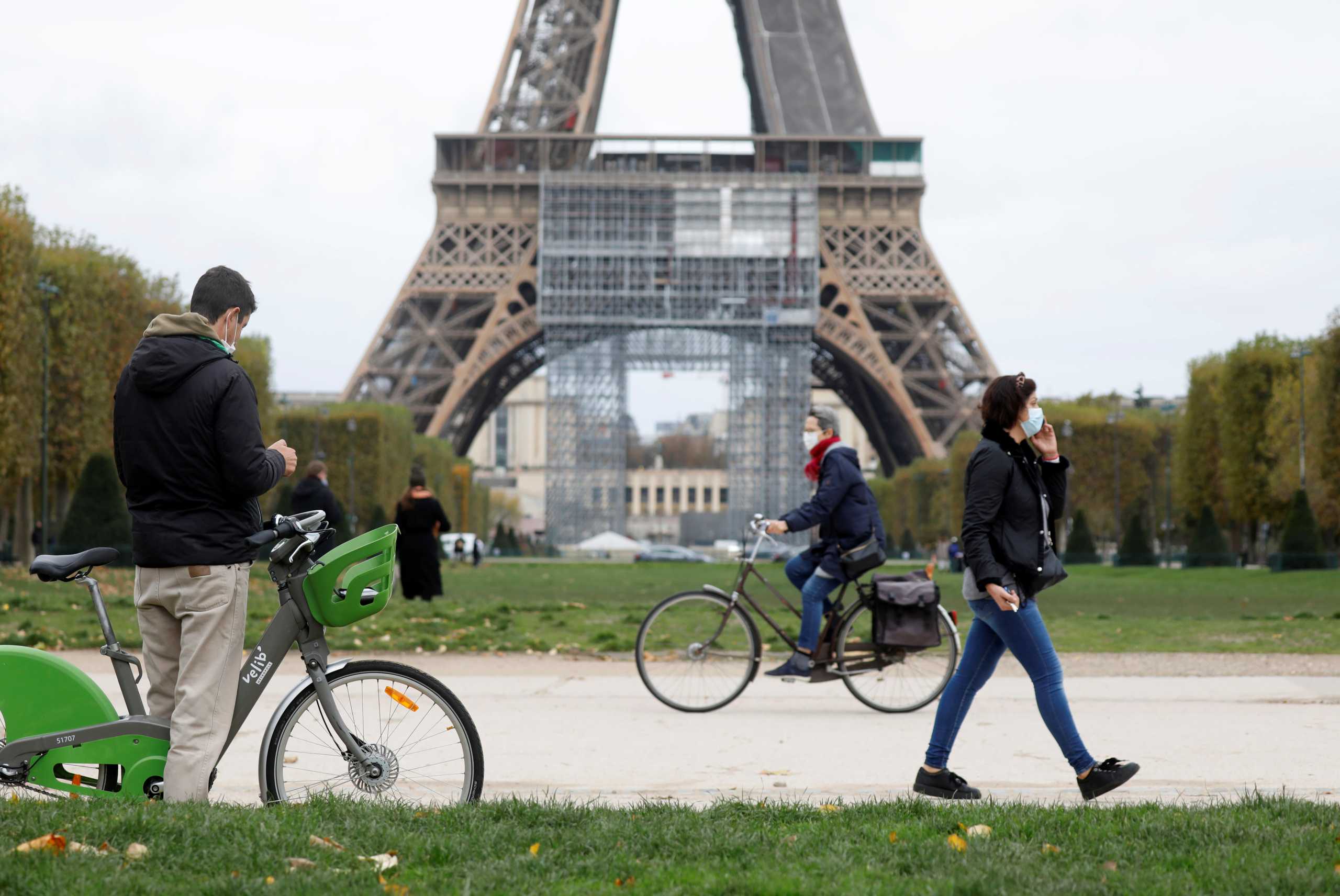 People pass by the Eiffel Tower before the national lockdown introduced as part of the new COVID-19 measures to fight a second wave of the coronavirus disease, in Paris, France, October 29, 2020.   REUTERS