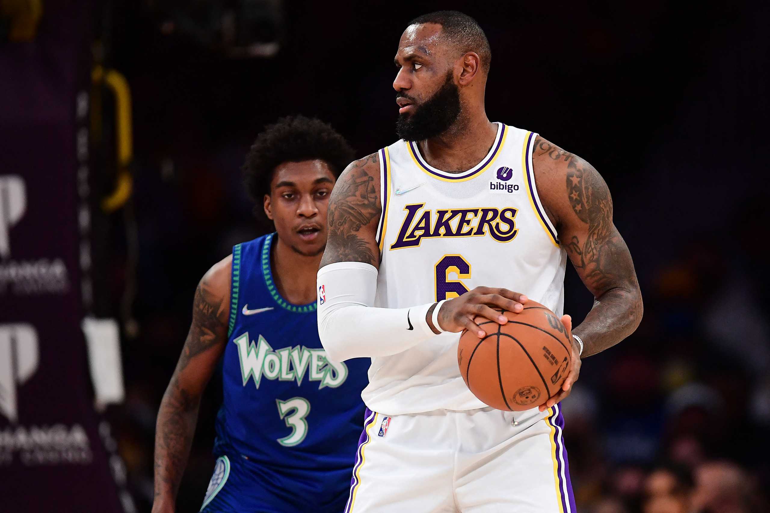 Jan 2, 2022; Los Angeles, California, USA; Los Angeles Lakers forward LeBron James (6) controls the ball in front of Minnesota Timberwolves forward Jaden McDaniels (3) during the first half at Crypto.com Arena. Mandatory Credit: Gary A. Vasquez-USA TODAY Sports