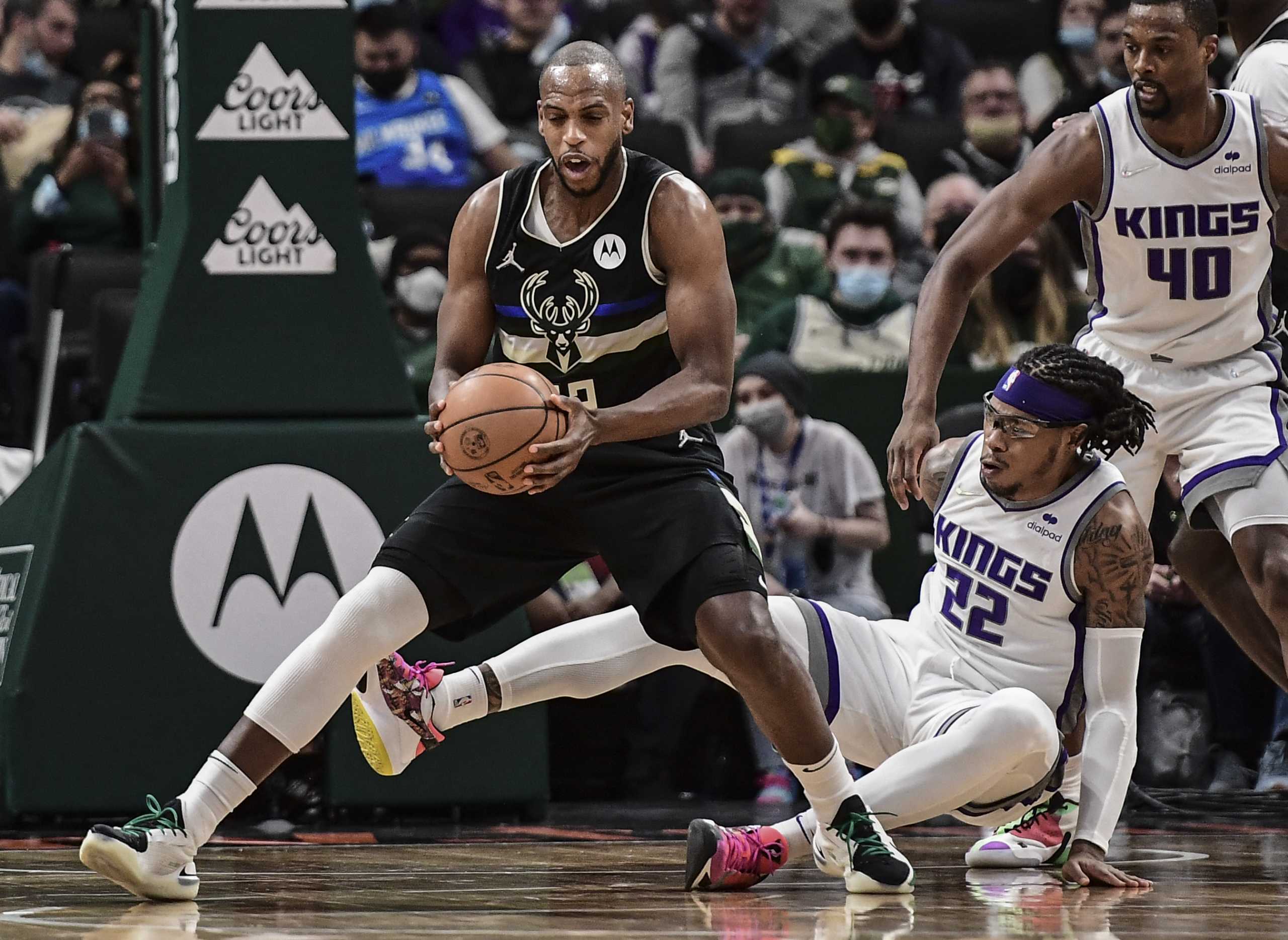 Jan 22, 2022; Milwaukee, Wisconsin, USA; Milwaukee Bucks forward Khris Middleton (left) drives to the basket against Sacramento Kings center Richaun Holmes (right) in the third quarter at Fiserv Forum. Mandatory Credit: Benny Sieu-USA TODAY Sports