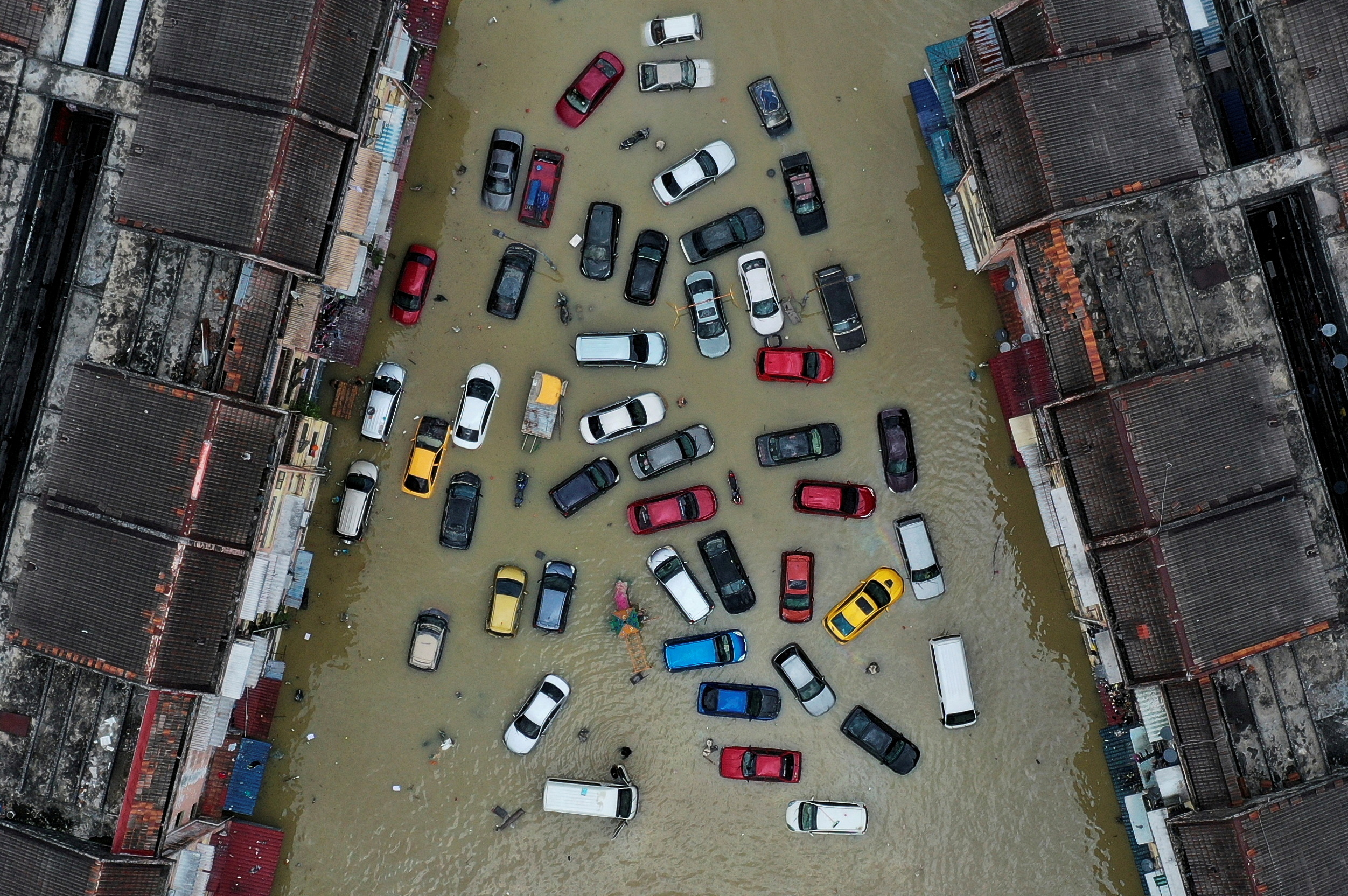 FILE PHOTO: FILE PHOTO: Aerial view shows vehicles and buildings inundated by floods in Shah Alam's Taman Sri Muda, one of the worst hit neighbourhoods in Selangor state, Malaysia, December 21, 2021. Picture taken with a drone. REUTERS