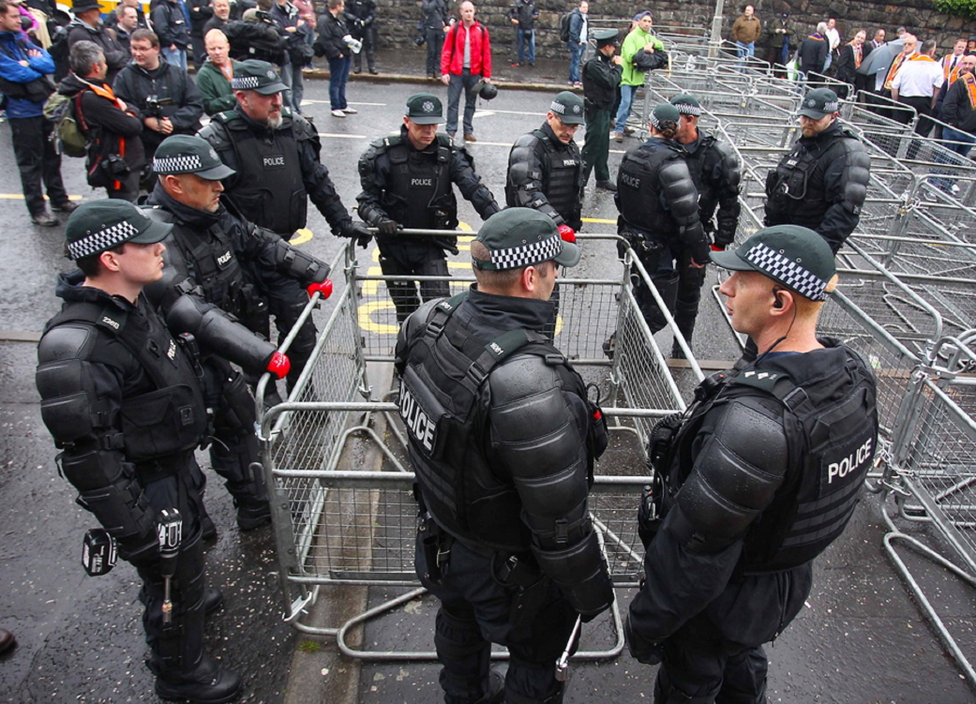 epa07261135 (FILE) - Police construct barriers as the Ligoneil Lodge arrive back to the stopping point on the Woodvale road following a parades commission ruling on this particular parade that rules any bands men from passing the Ardoyne Shopfront on the Crumlin road in north Belfast, Northern Ireland, 12 July 2014 (reissued 04 January 2019). British media reports on 04 January 2019 state Police Service of Northern Ireland, PSNI has asked up to 1,000 officers to be deployed in Northern Ireland as a reinforcement in case of a no-deal Brexit. Authorities fear violence could occur if a hard border will be established between EU member Ireland and Northern Ireland.  EPA