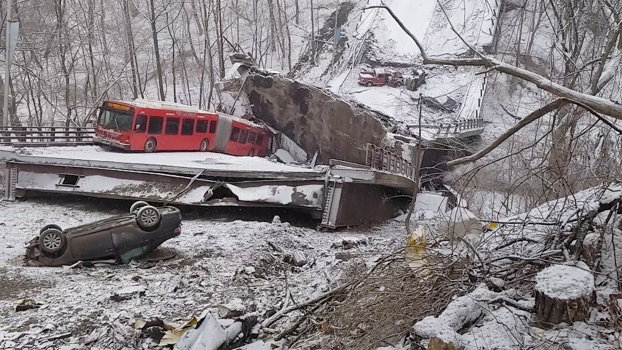Damaged vehicles are seen at the scene of a collapsed bridge in Pittsburgh, Pennsylvania, U.S. January 28, 2022, in this image obtained from a social media video. John Taylor via REUTERS MANDATORY CREDIT THIS IMAGE HAS BEEN SUPPLIED BY A THIRD PARTY. NO RESALES. NO ARCHIVES