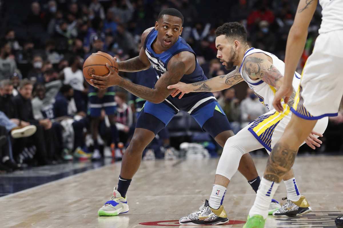 Jan 16, 2022; Minneapolis, Minnesota, USA; Minnesota Timberwolves guard McKinley Wright IV (25) works around Golden State Warriors guard Chris Chiozza (2) in the fourth quarter at Target Center. Mandatory Credit: Bruce Kluckhohn-USA TODAY Sports