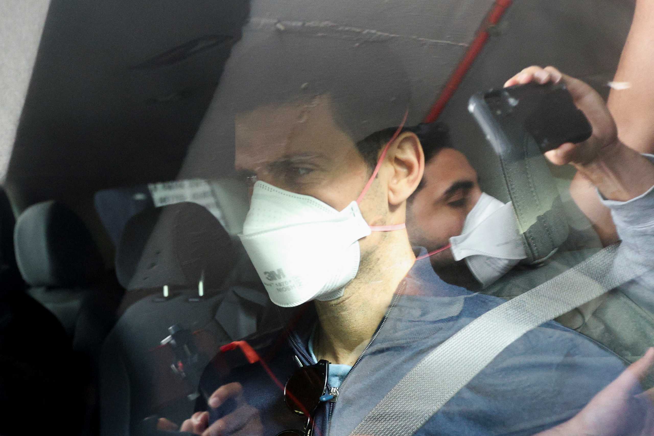 Serbian tennis player Novak Djokovic departs the Park Hotel while under immigration detention, to convene with his legal team after his visa to play in the Australian Open was cancelled a second time, in Melbourne, Australia, January 16, 2022. REUTERS