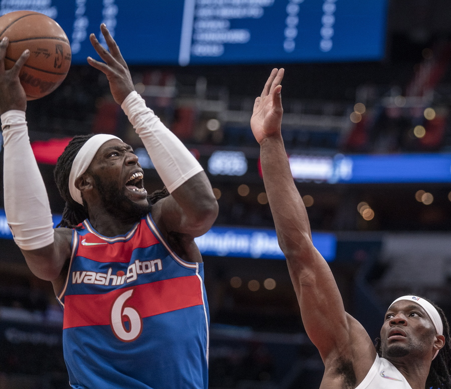 epa09562464 Washington Wizards center Montrezl Harrell (L) in action during the NBA basketball game between the Toronto Raptors and the Washington Wizards at Capital One Arena in Washington,DC, USA, 03 November 2021.  EPA
