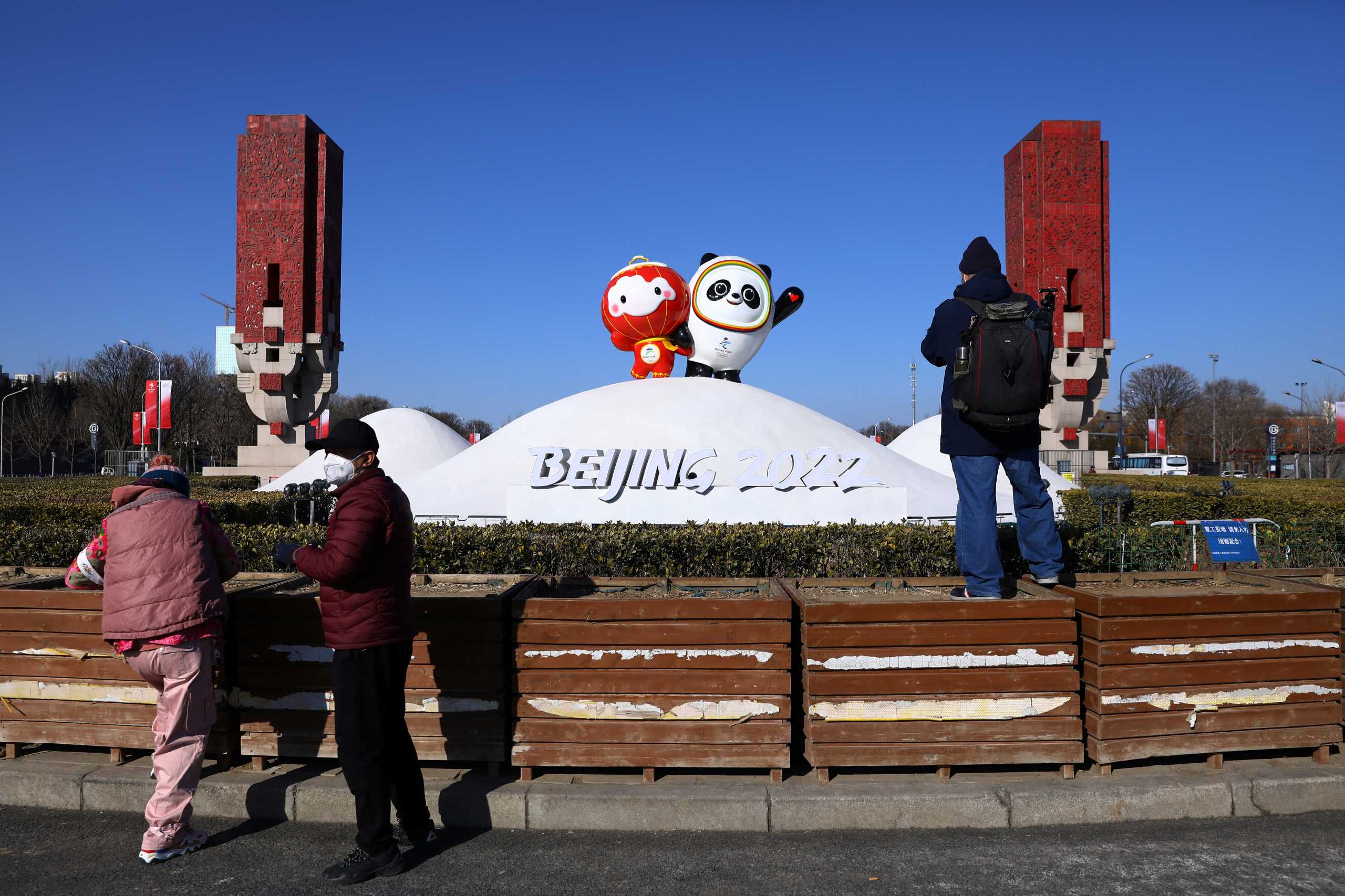 People take pictures of statues of the Beijing 2022 Winter Olympics Mascots, near the Winter Olympic Village ahead of the Beijing 2022 Winter Olympics in Beijing, China January 27, 2022. REUTERS
