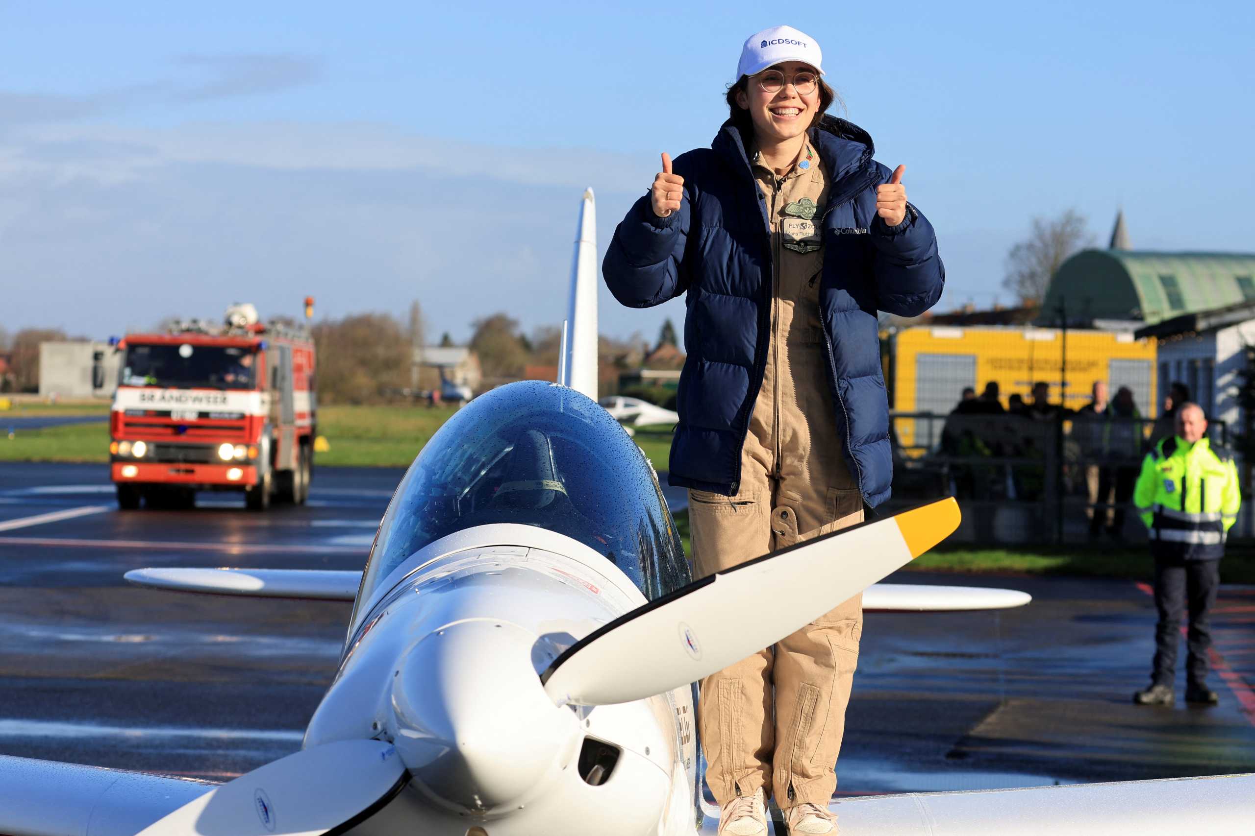 Belgian-British pilot Zara Rutherford, 19, gestures following her landing at Kortrijk-Wevelgem Airport, after a round-the-world trip in a light aircraft, becoming the youngest female pilot to circle the planet alone, in Wevelgem, Belgium, January 20, 2022. REUTERS