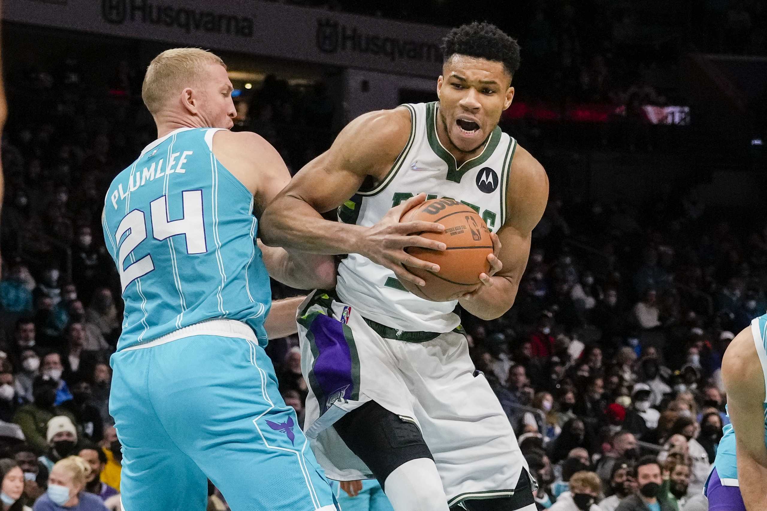 Jan 10, 2022; Charlotte, North Carolina, USA; Milwaukee Bucks forward Giannis Antetokounmpo (34) tries to get around Charlotte Hornets center Mason Plumlee (24) during the second half at the Spectrum Center. Mandatory Credit: Jim Dedmon-USA TODAY Sports