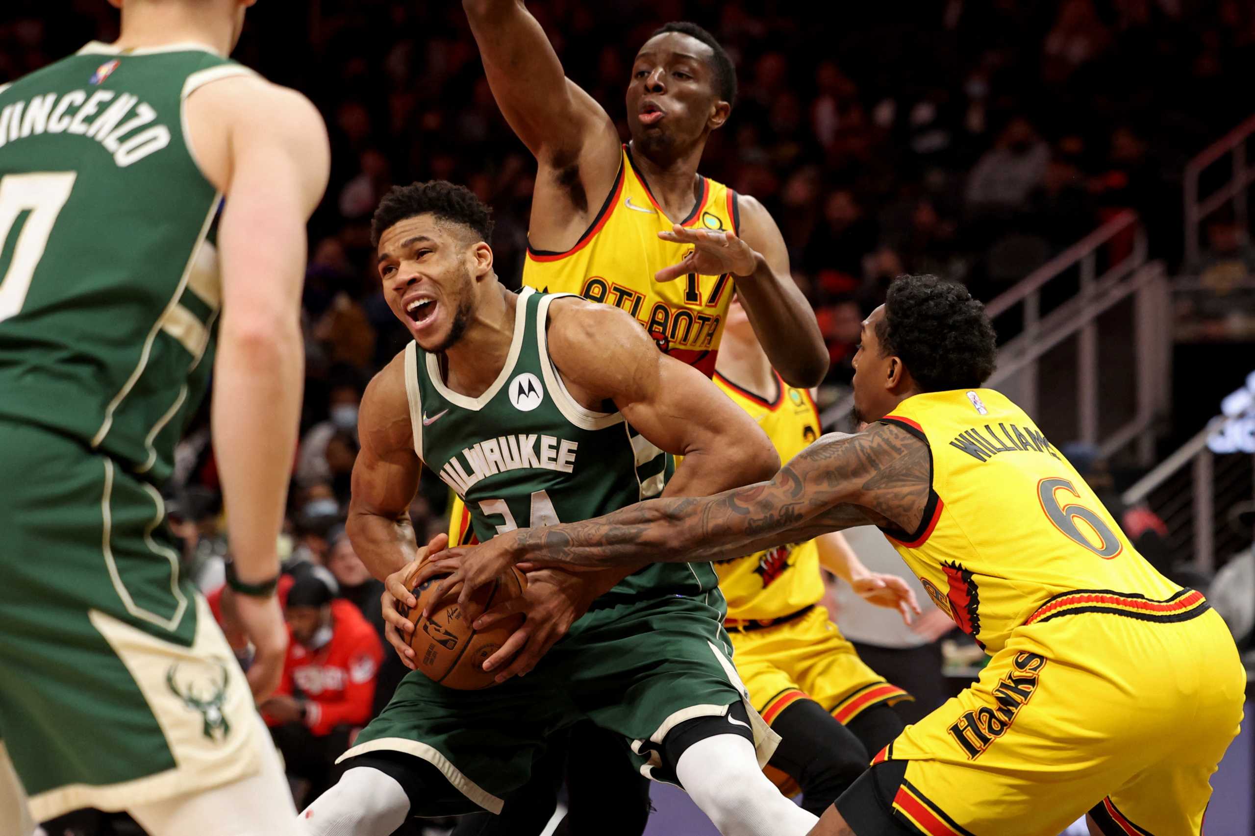 Jan 17, 2022; Atlanta, Georgia, USA; Milwaukee Bucks forward Giannis Antetokounmpo (34) drives against Atlanta Hawks forward Onyeka Okongwu (17) and guard Lou Williams (6) during the fourth quarter at State Farm Arena. Mandatory Credit: Jason Getz-USA TODAY Sports