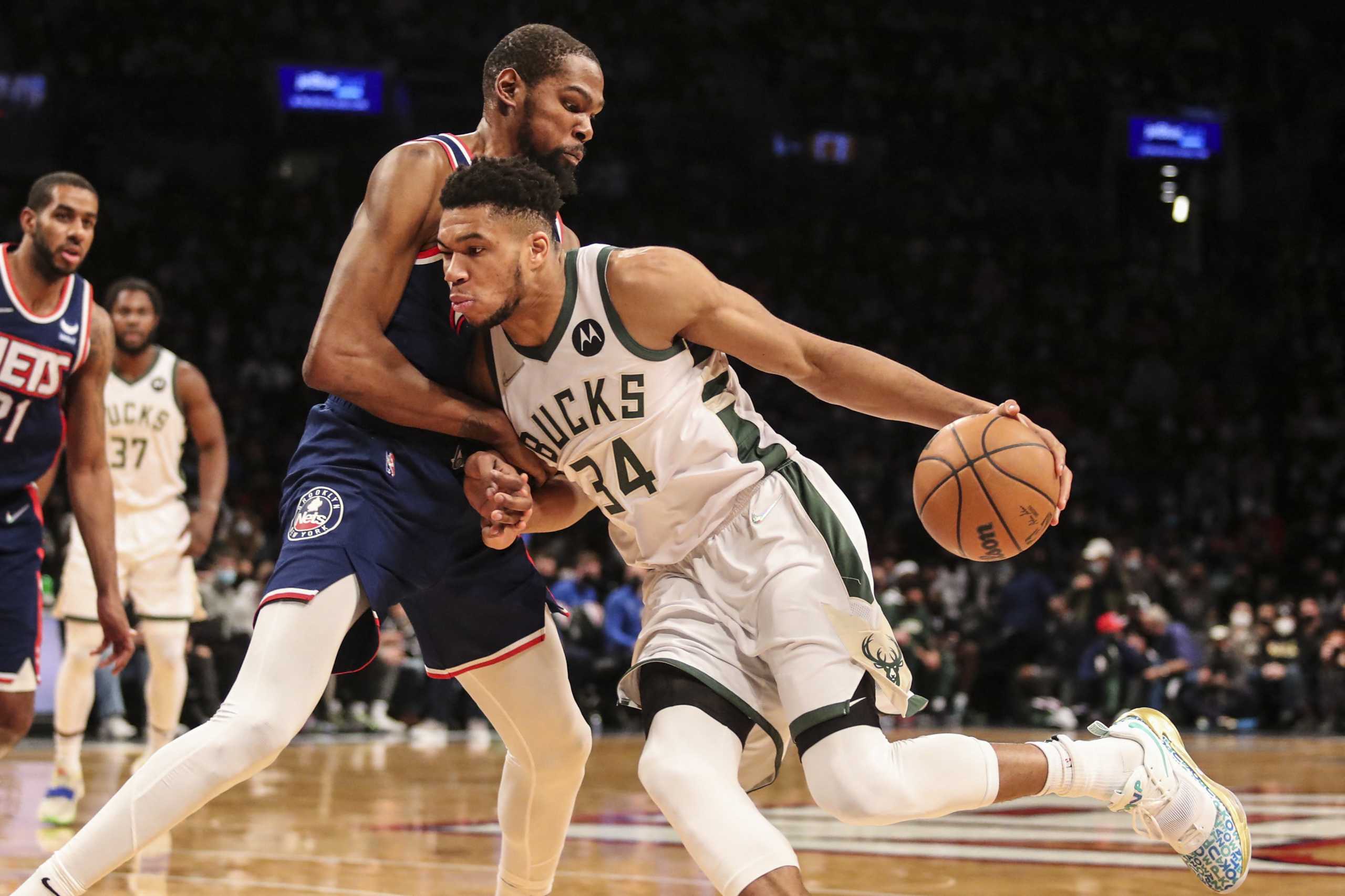 Jan 7, 2022; Brooklyn, New York, USA;  Milwaukee Bucks forward Giannis Antetokounmpo (34) drives past Brooklyn Nets forward Kevin Durant (7) in the first quarter at Barclays Center. Mandatory Credit: Wendell Cruz-USA TODAY Sports