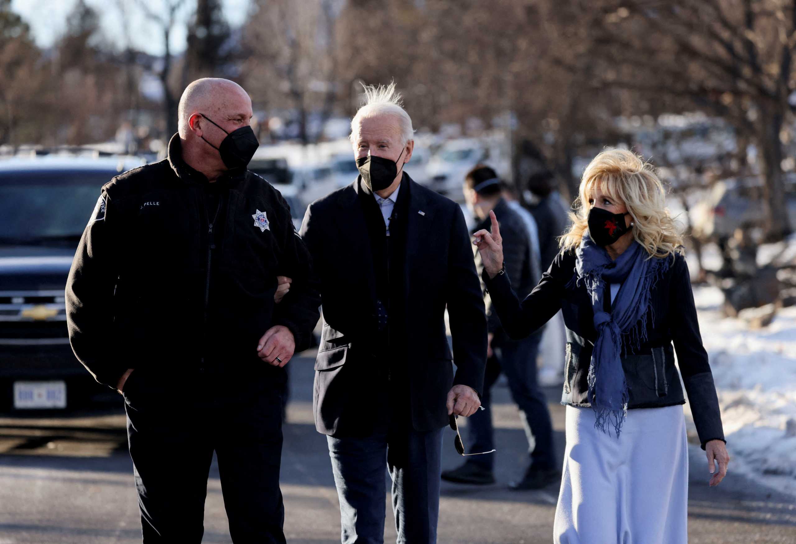 U.S. President Joe Biden and first lady Jill Biden speak with Boulder County Sheriff Joe Pelle as they tour a neighborhood in Louisville, Colorado, U.S., January 7, 2022. REUTERS
