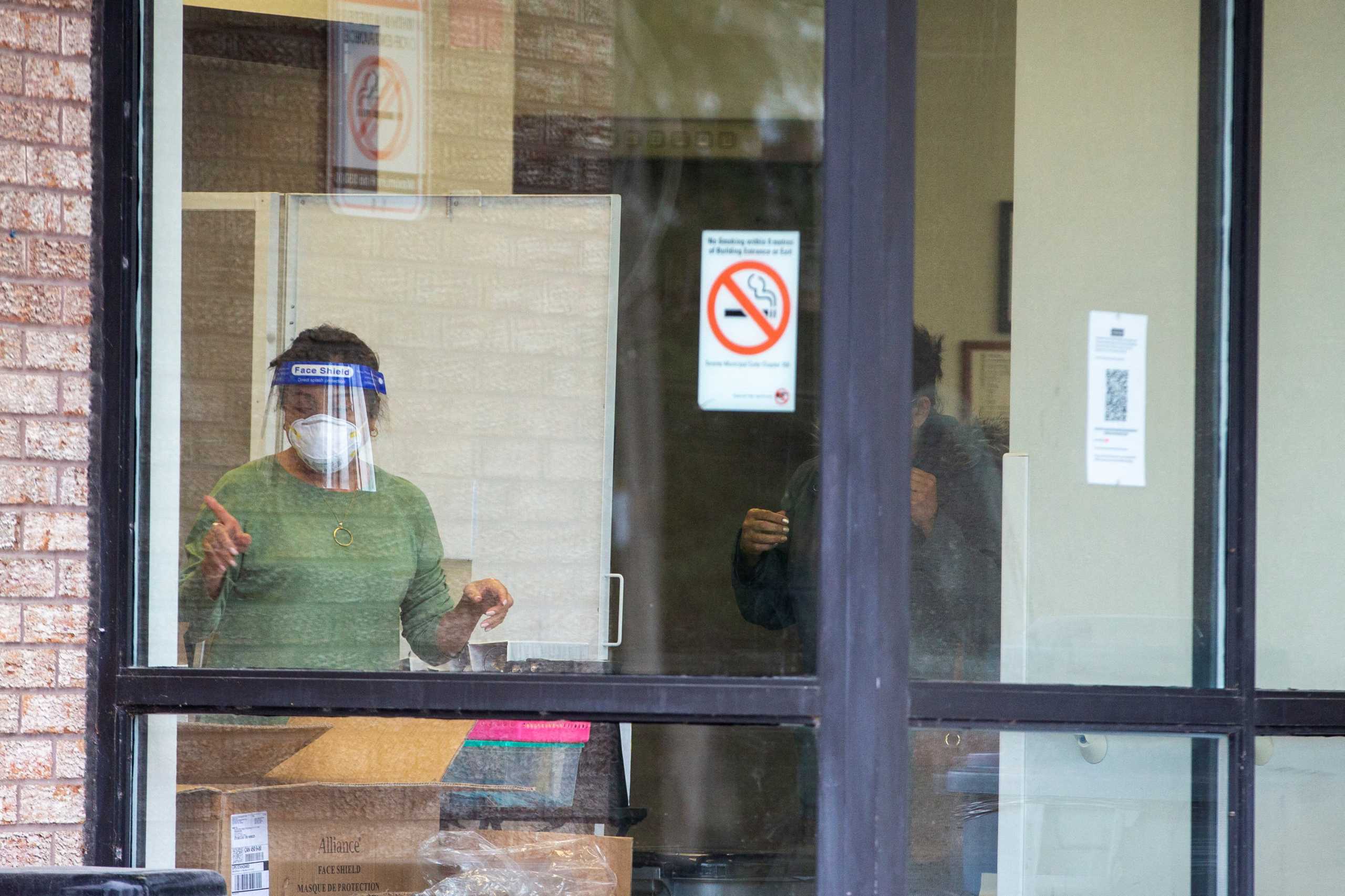 An employe screens a person entering Eatonville Care Centre after new provincial rules limiting visitations at long term care homes come into effect due to spiking coronavirus disease (COVID-19) case numbers in Toronto, Ontario, Canada December 30, 2021.  REUTERS