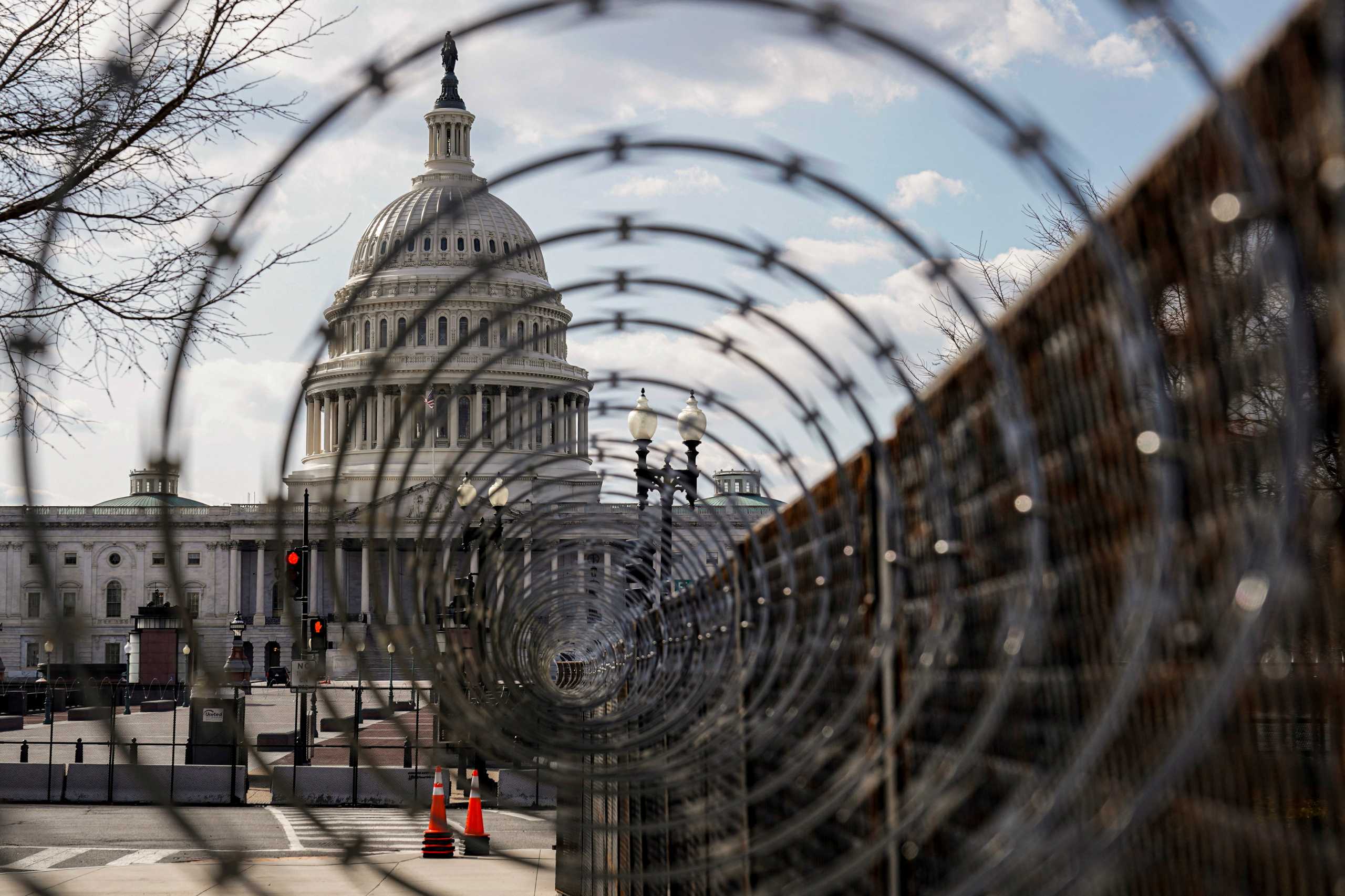 FILE PHOTO: The U.S. Capitol is seen through razor wire in Washington, U.S., March 4, 2021. REUTERS