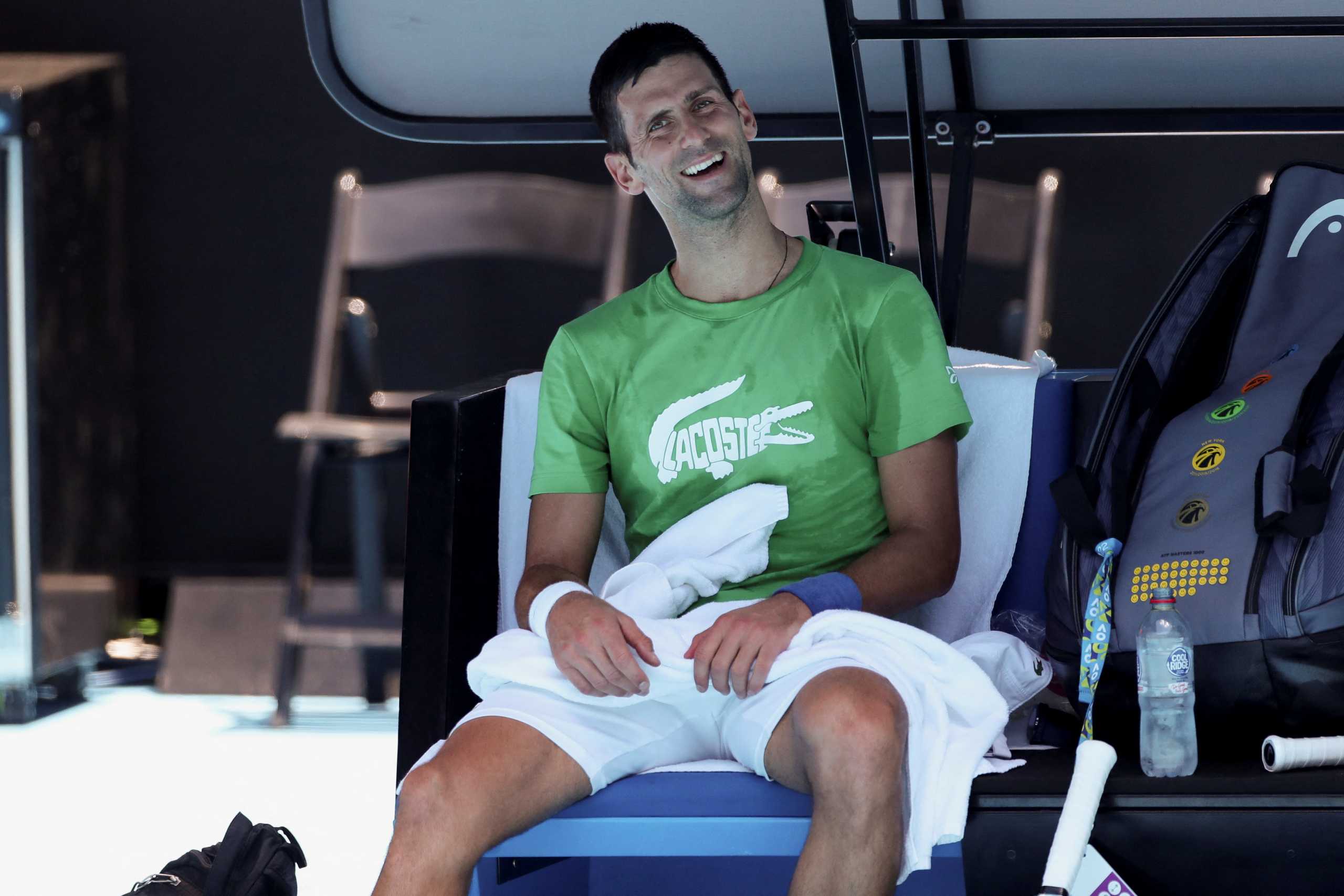 Serbian tennis player Novak Djokovic takes a break as he practices at Melbourne Park as questions remain over the legal battle regarding his visa to play in the Australian Open in Melbourne, Australia, January 13, 2022.  REUTERS