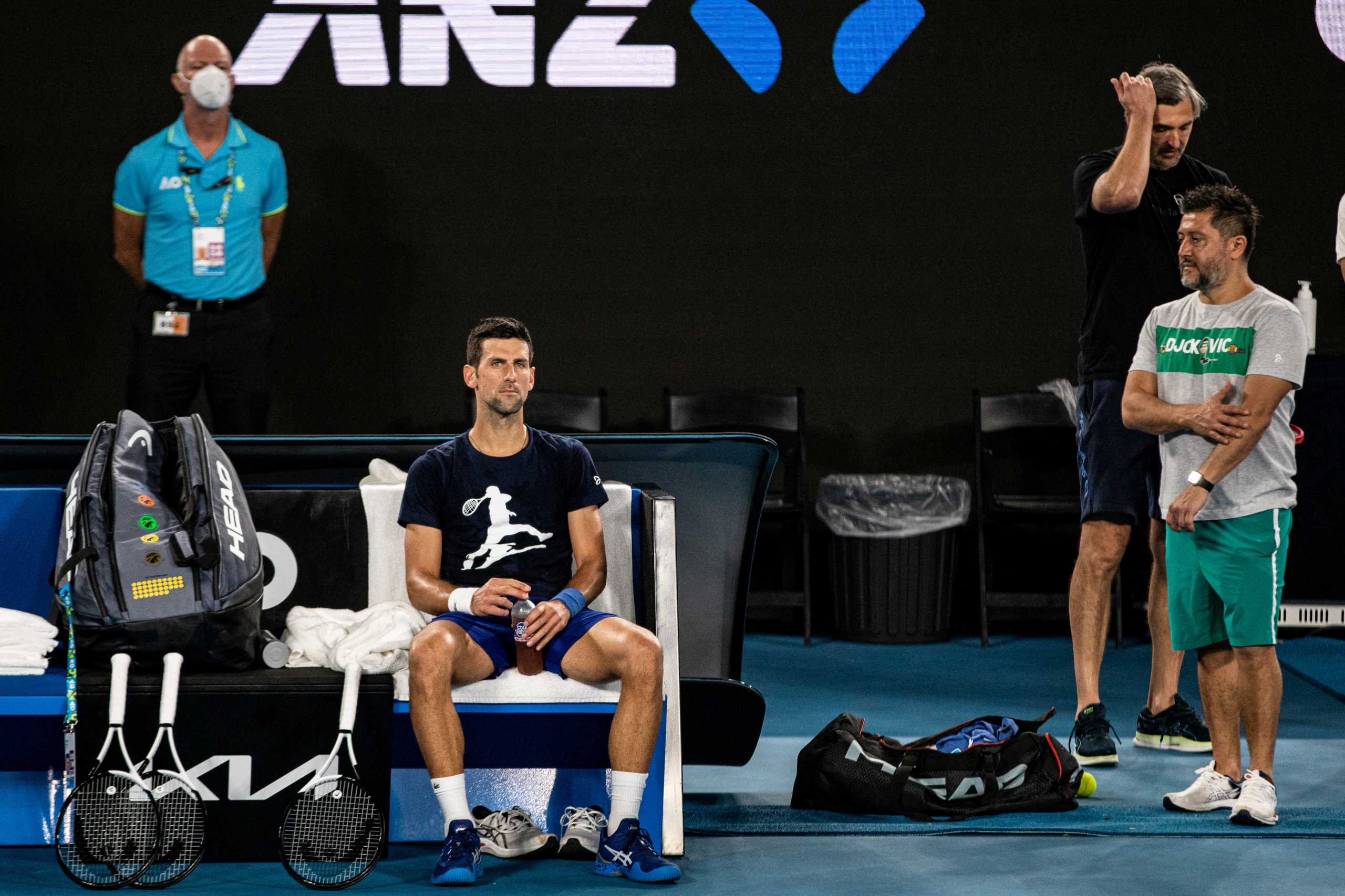 Serbian tennis player Novak Djokovic rests during a training session at Melbourne Park as questions remain over the legal battle regarding his visa to play in the Australian Open in Melbourne, Australia, January 14, 2022.  AAP Image