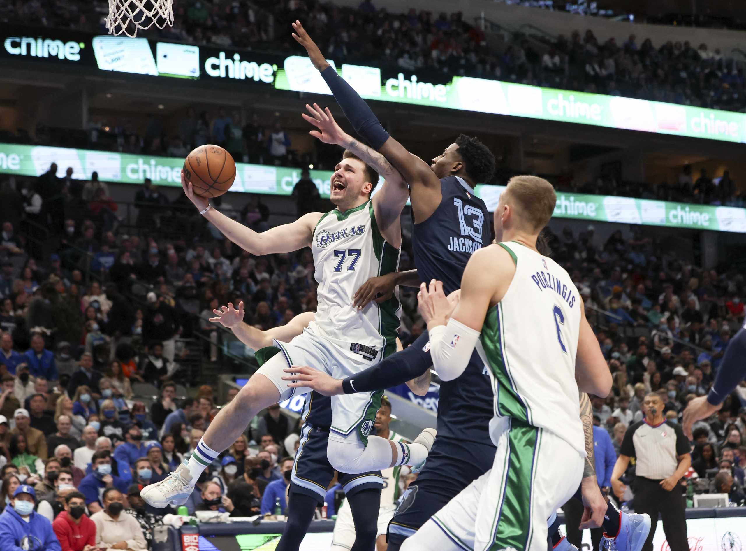 Jan 23, 2022; Dallas, Texas, USA;  Dallas Mavericks guard Luka Doncic (77) shoots past Memphis Grizzlies forward Jaren Jackson Jr. (13) during the second half at American Airlines Center. Mandatory Credit: Kevin Jairaj-USA TODAY Sports