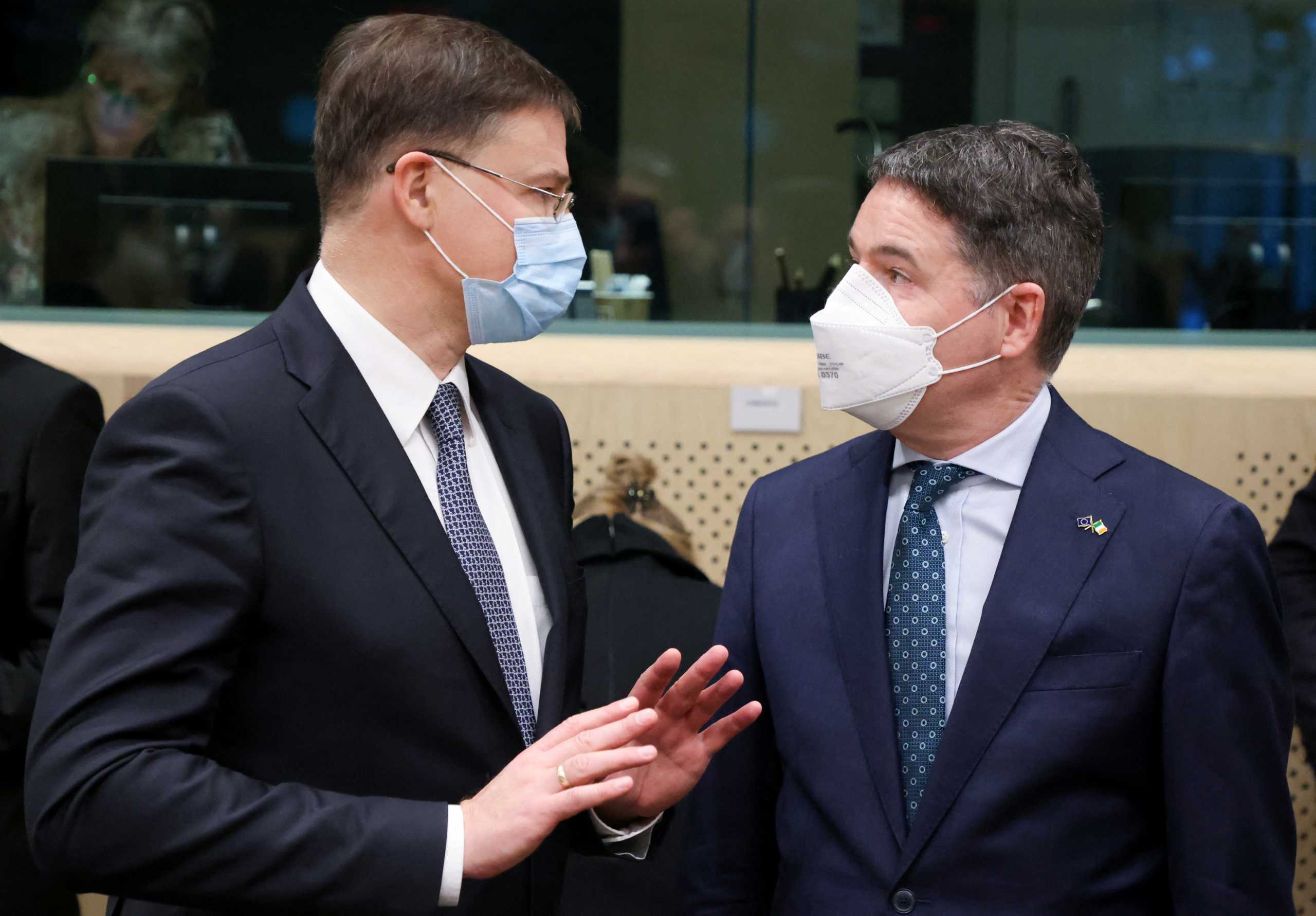 Trade Commissioner Valdis Dombrovskis gestures as he interacts with President of the Eurogroup and Irish Minister for Finance Paschal Donohoe during a Euro zone finance ministers meeting in Brussels, Belgium January 17, 2022. REUTERS