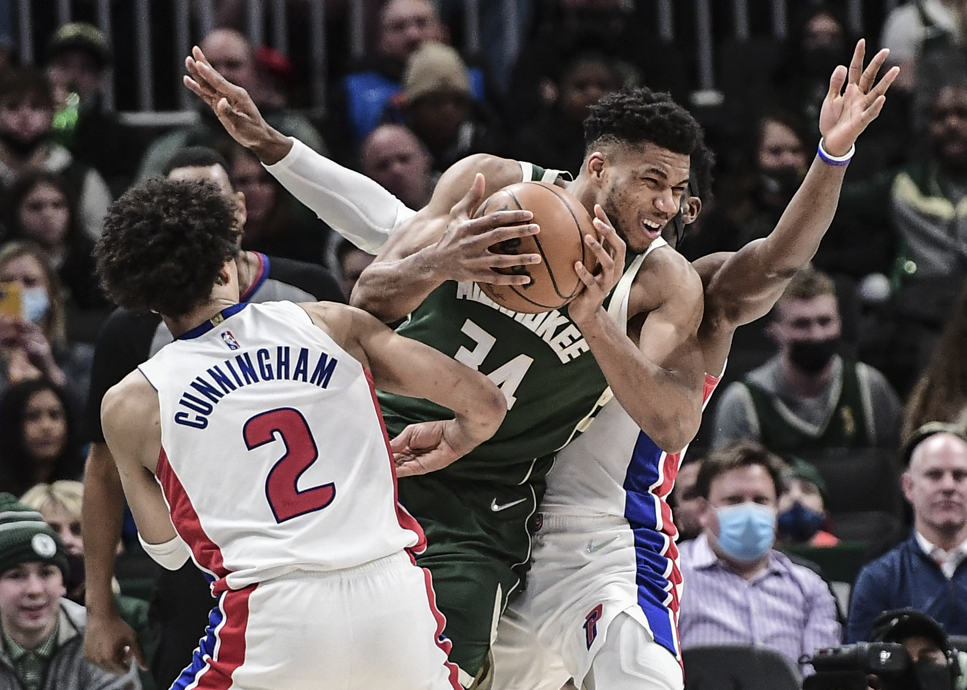 Jan 3, 2022; Milwaukee, Wisconsin, USA; Milwaukee Bucks forward Giannis Antetokounmpo (34) gets pressure from Detroit Pistons guard Cade Cunningham (2) and guard Hamidou Diallo (6) in the fourth quarter at Fiserv Forum. Mandatory Credit: Benny Sieu-USA TODAY Sports