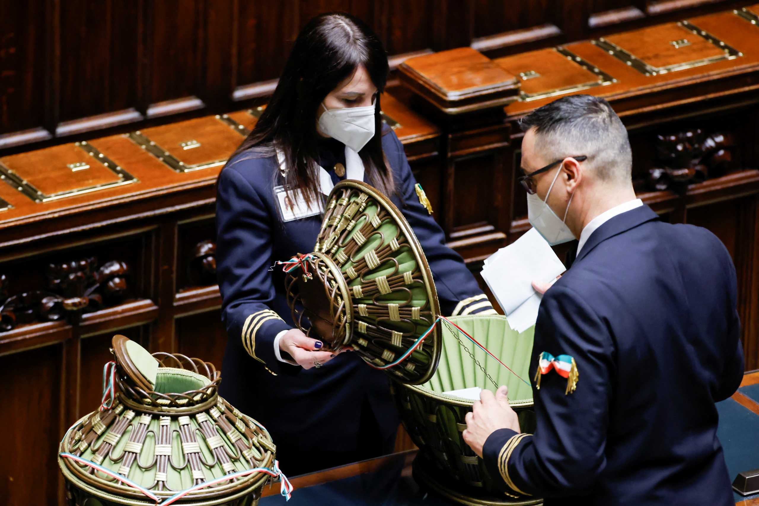 Parliament assistants open a ballot box to count the votes casted to elect the country's new president, at the Chamber of Deputies in Rome, Italy, January 24, 2022. REUTERS