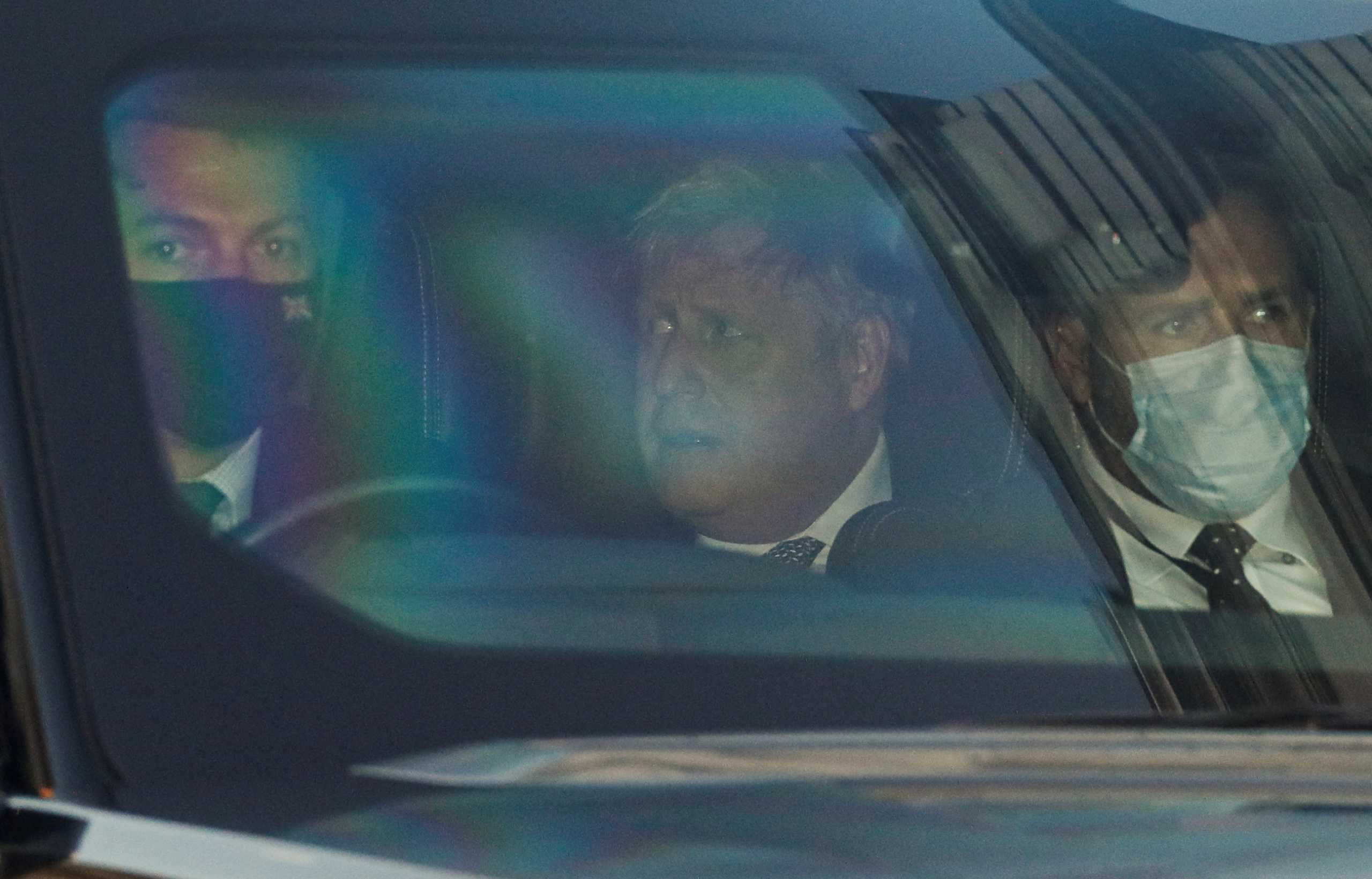 British Prime Minister Boris Johnson reacts in a car as he leaves the Parliament in London, Britain, January 12, 2022. REUTERS