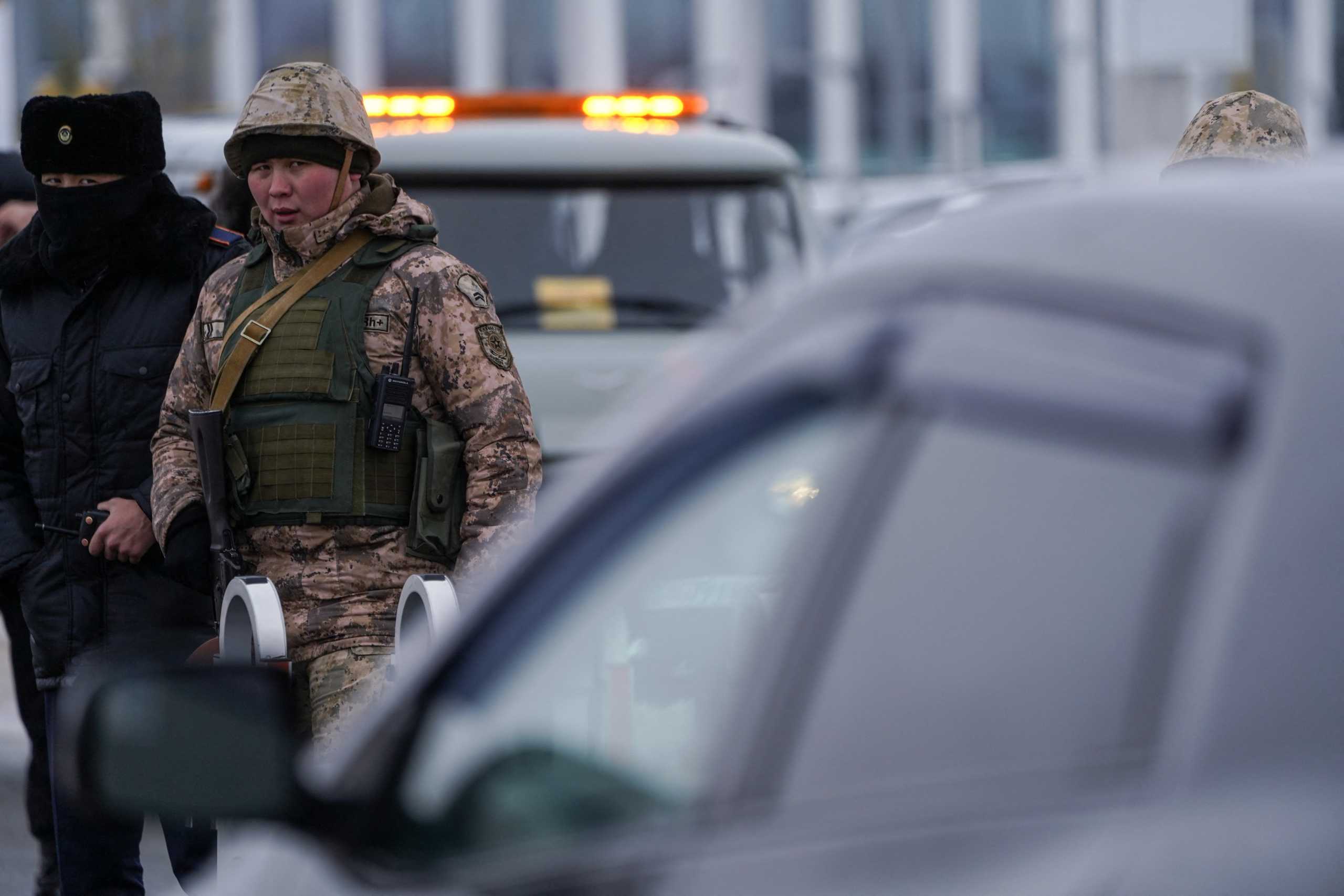 Kazakh law enforcement officers stand guard at a checkpoint, after mass protests triggered by fuel price increase erupted all over the country, in Nur-Sultan, Kazakhstan January 7, 2022. Picture taken January 7, 2022. REUTERS
