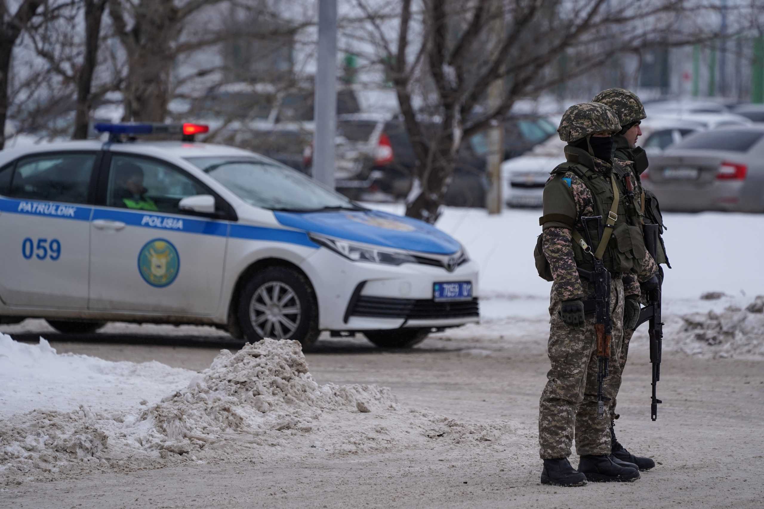 Kazakh law enforcement officers stand guard at a checkpoint, after mass protests triggered by fuel price increase erupted all over the country, in Nur-Sultan, Kazakhstan January 7, 2022. Picture taken January 7, 2022. REUTERS
