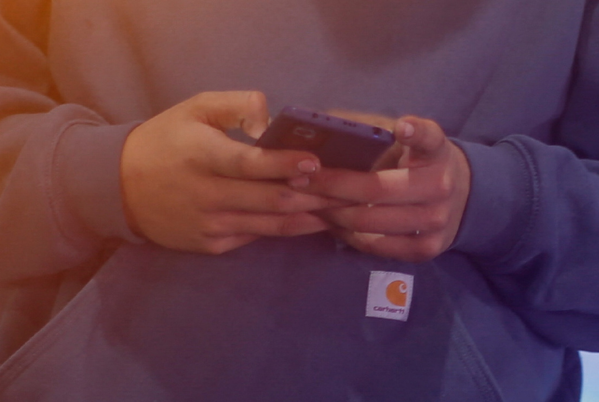 A man checks his phone near an attraction at a Christmas fair in Mexico City, Mexico December 22, 2021. Picture taken December 22, 2021. REUTERS