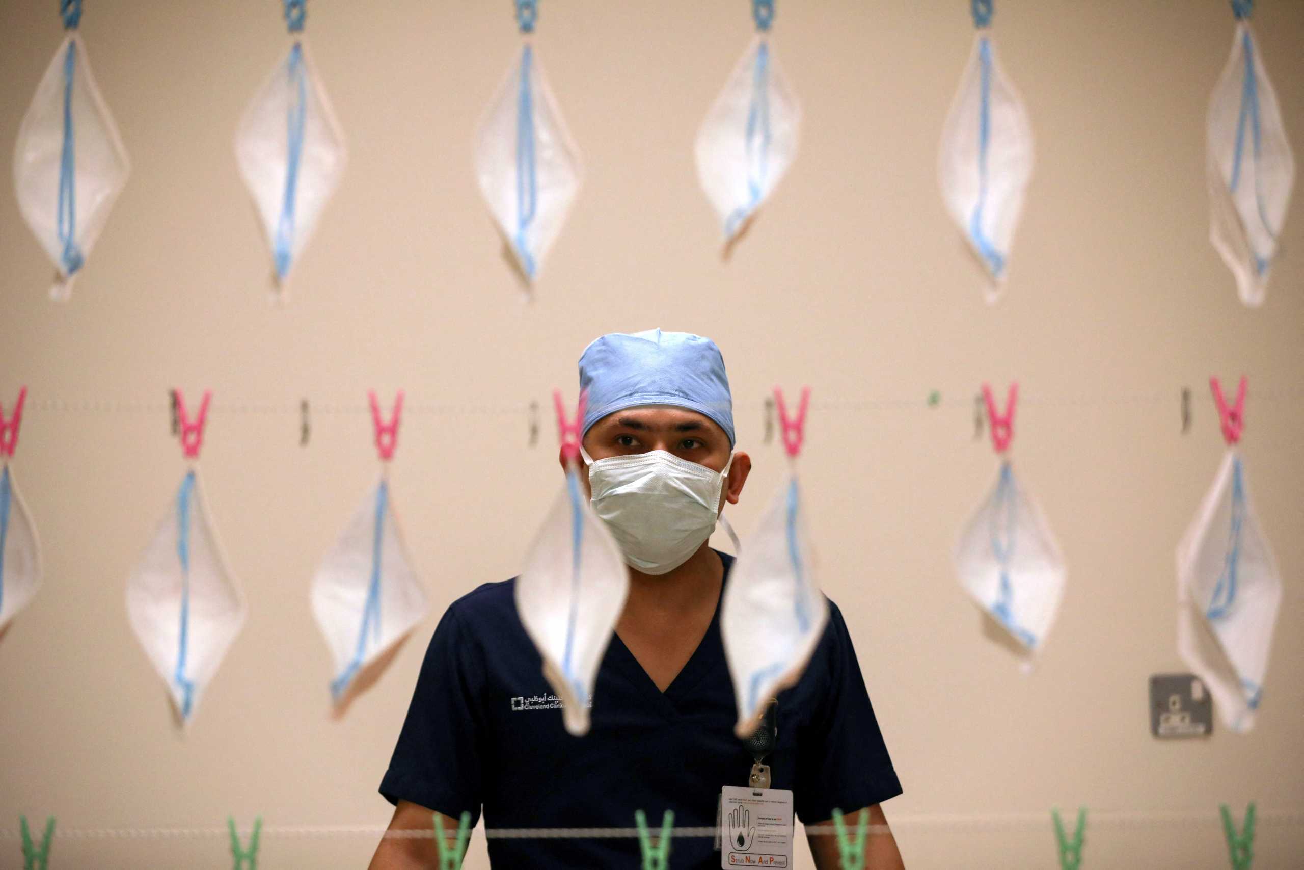 FILE PHOTO: A technician hangs N95 face masks to be sterilized with UVC light, amid the coronavirus disease (COVID-19) outbreak, at the Cleveland Clinic hospital in Abu Dhabi, United Arab Emirates, April 20, 2020. REUTERS