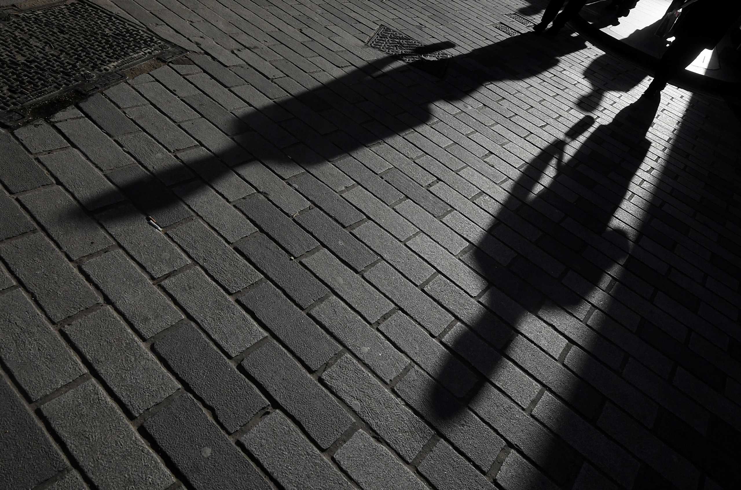 FILE PHOTO: The shadows of workers are seen in the City of London financial district, London, Britain, January 25, 2018. Picture taken January 25, 2018. REUTERS