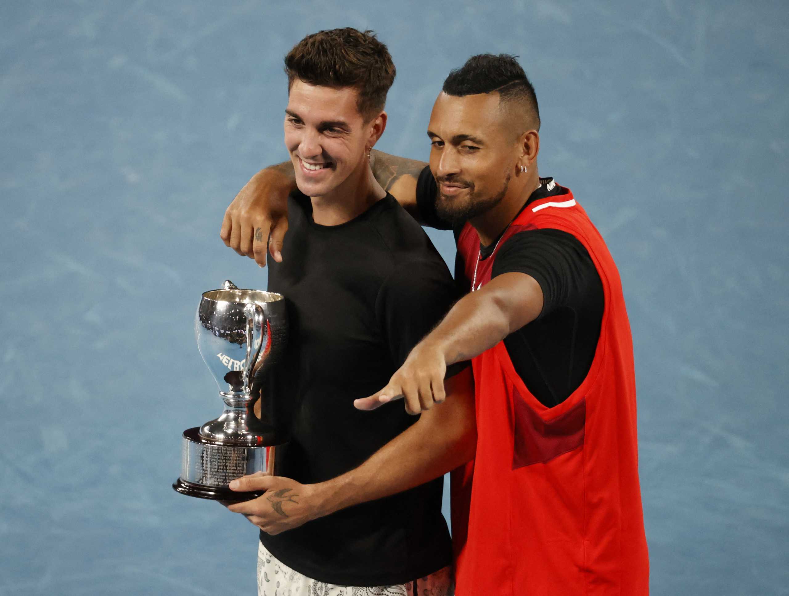 Tennis - Australian Open - Men's Doubles Final - Melbourne Park, Melbourne, Australia - January 29, 2022 Australia's Nick Kyrgios and Thanasi Kokkinakis celebrate winning the final against Australia's Matthew Ebden and Max Purcell with the trophy REUTERS