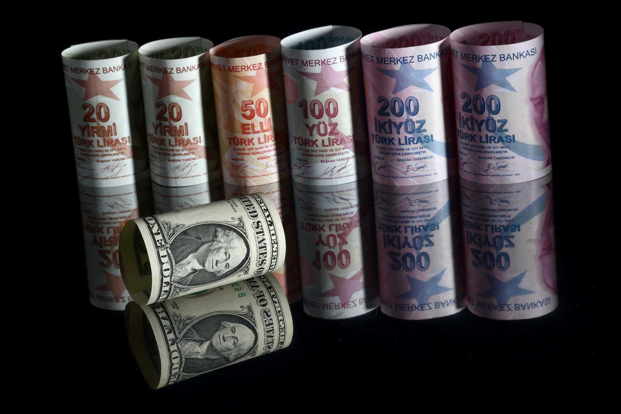 FILE PHOTO: A U.S. one dollar banknote is seen next to Turkish lira banknotes in this picture illustration in Istanbul, Turkey, November 23, 2021. REUTERS