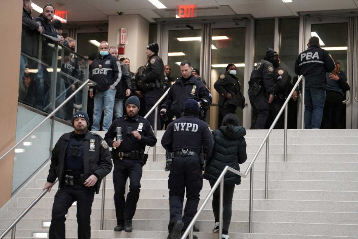 Police gather at a hospital near where NYPD officers were shot while responding to a domestic violence call in the Harlem neighborhood of New York City, U.S., January 21, 2022.   REUTERS