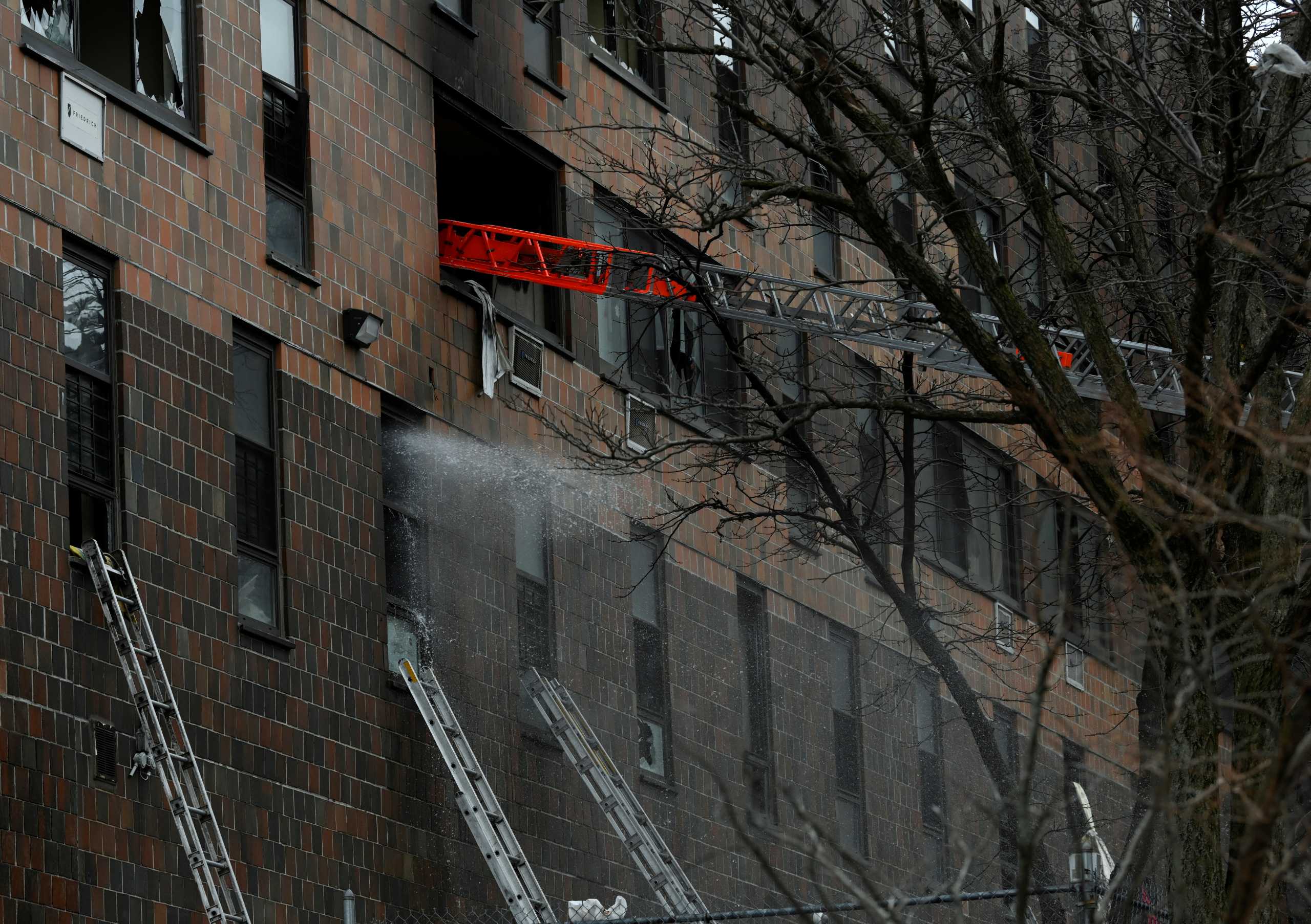 Emergency personnel from the FDNY respond to an apartment building fire in the Bronx borough of New York City, U.S., January 9, 2022.  REUTERS
