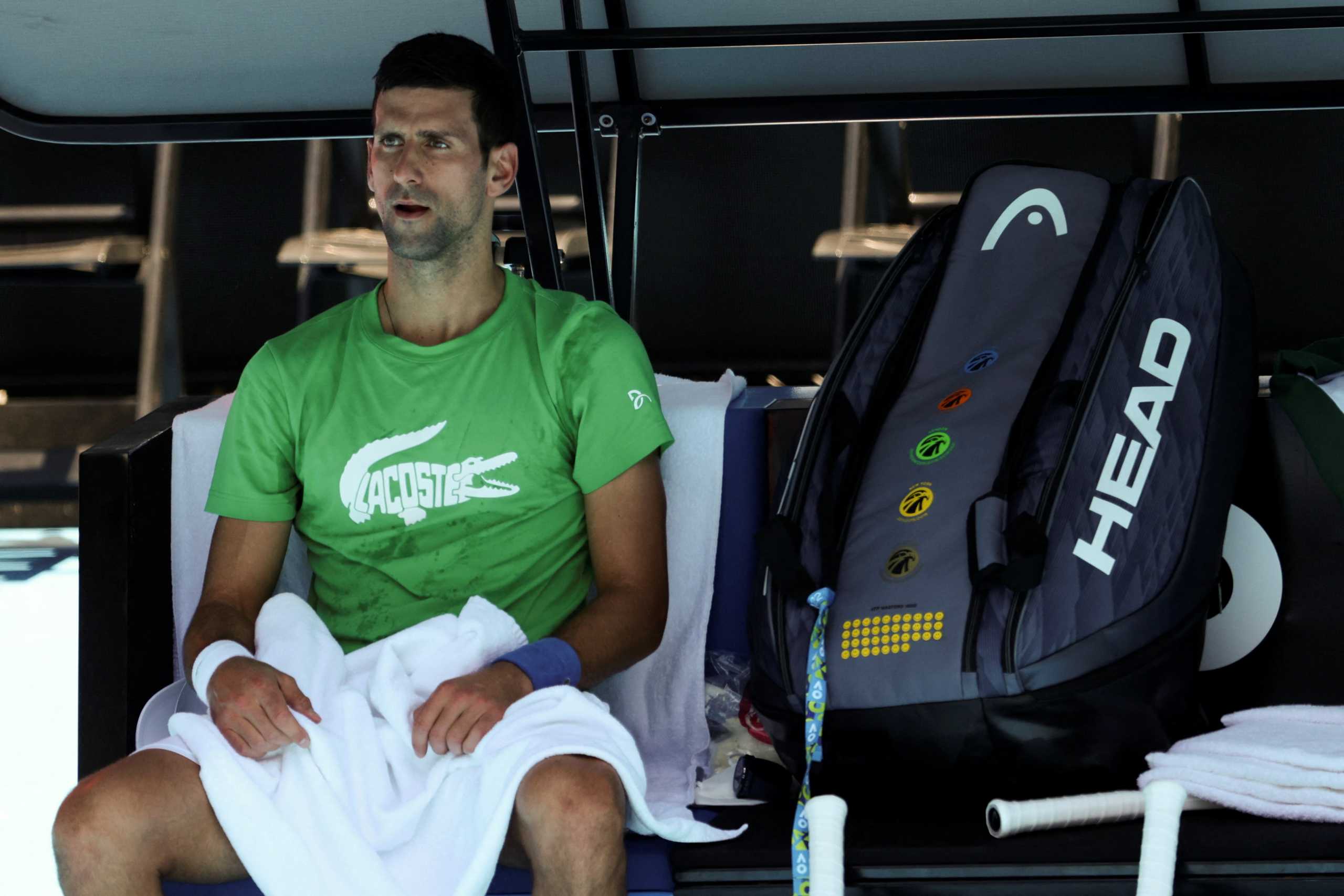 Serbian tennis player Novak Djokovic rests at Melbourne Park as questions remain over the legal battle regarding his visa to play in the Australian Open in Melbourne, Australia, January 13, 2022.  REUTERS