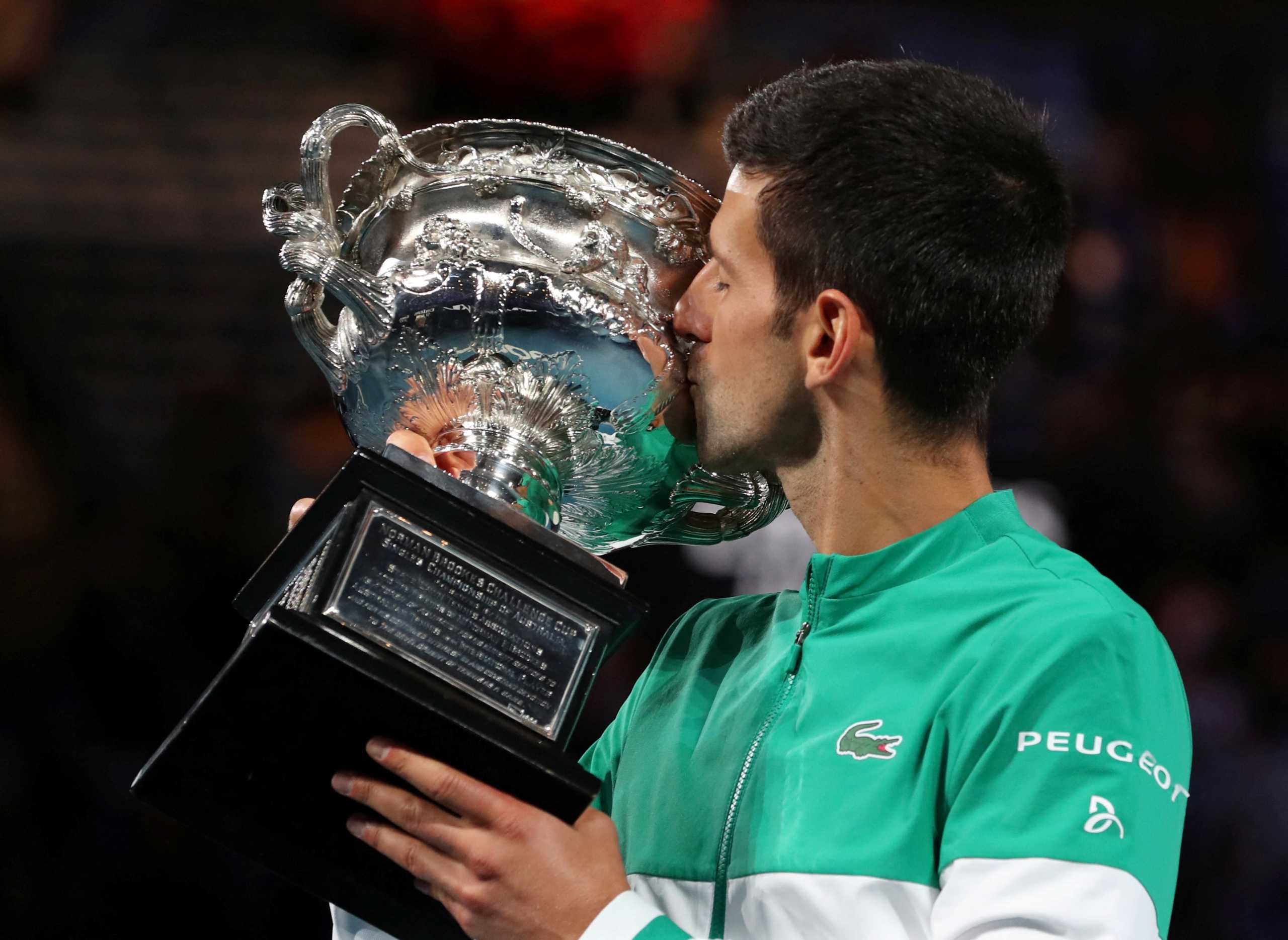 FILE PHOTO: Tennis - Serbia's Novak Djokovic celebrates with the trophy after winning his ninth Australian Open title - Melbourne Park, Melbourne, Australia, February 21, 2021.  REUTERS
