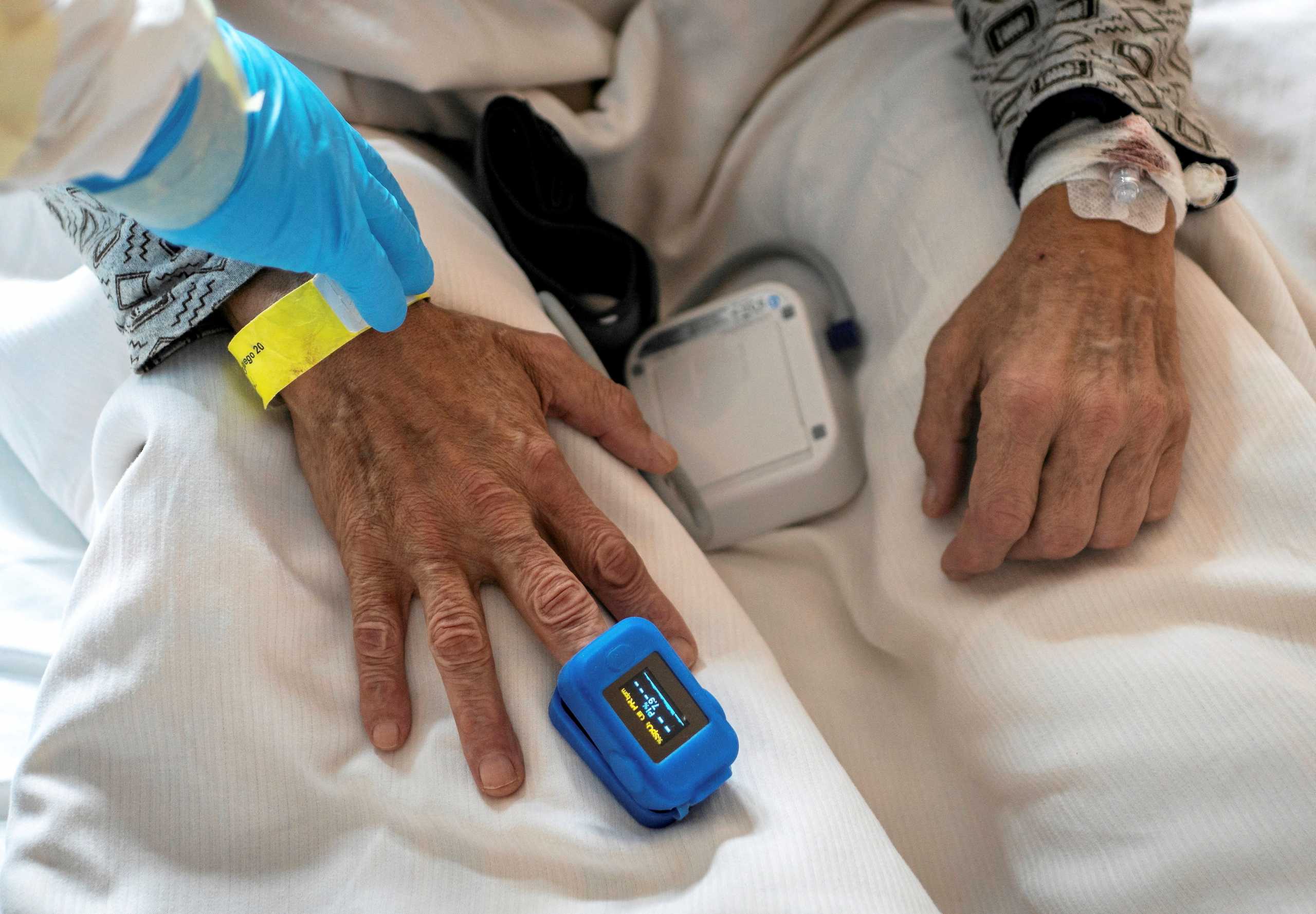 FILE PHOTO: A medical specialist treats a patient in a ward for people suffering from the coronavirus disease (COVID-19) at a city hospital in Gliwice, Poland, December 2, 2021. Picture taken December 2, 2021. Grzegorz Celejewski