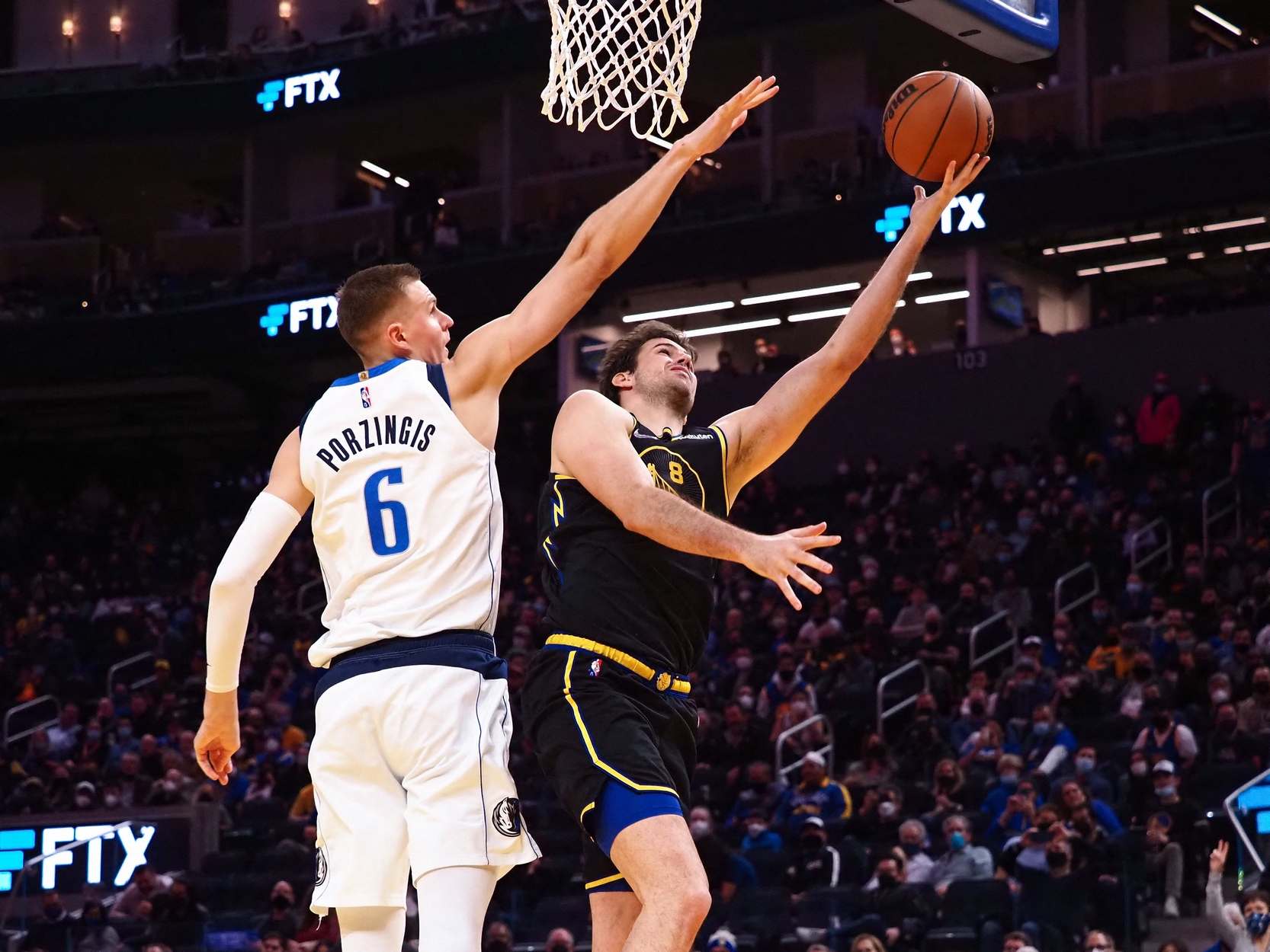 Jan 25, 2022; San Francisco, California, USA; Golden State Warriors forward Nemanja Bjelica (8) scores against Dallas Mavericks forward-center Kristaps Porzingis (6) during the fourth quarter at Chase Center. Mandatory Credit: Kelley L Cox-USA TODAY Sports