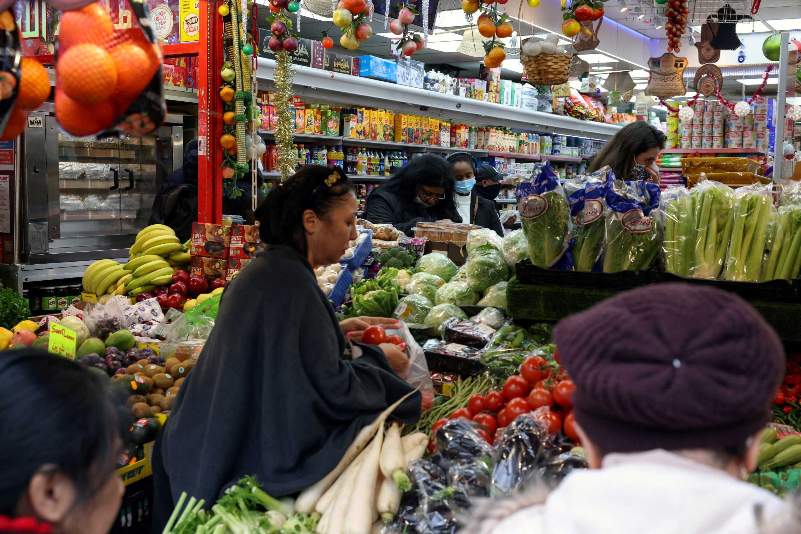 FILE PHOTO: People shop at a supermarket in London, Britain December 24, 2021. REUTERS